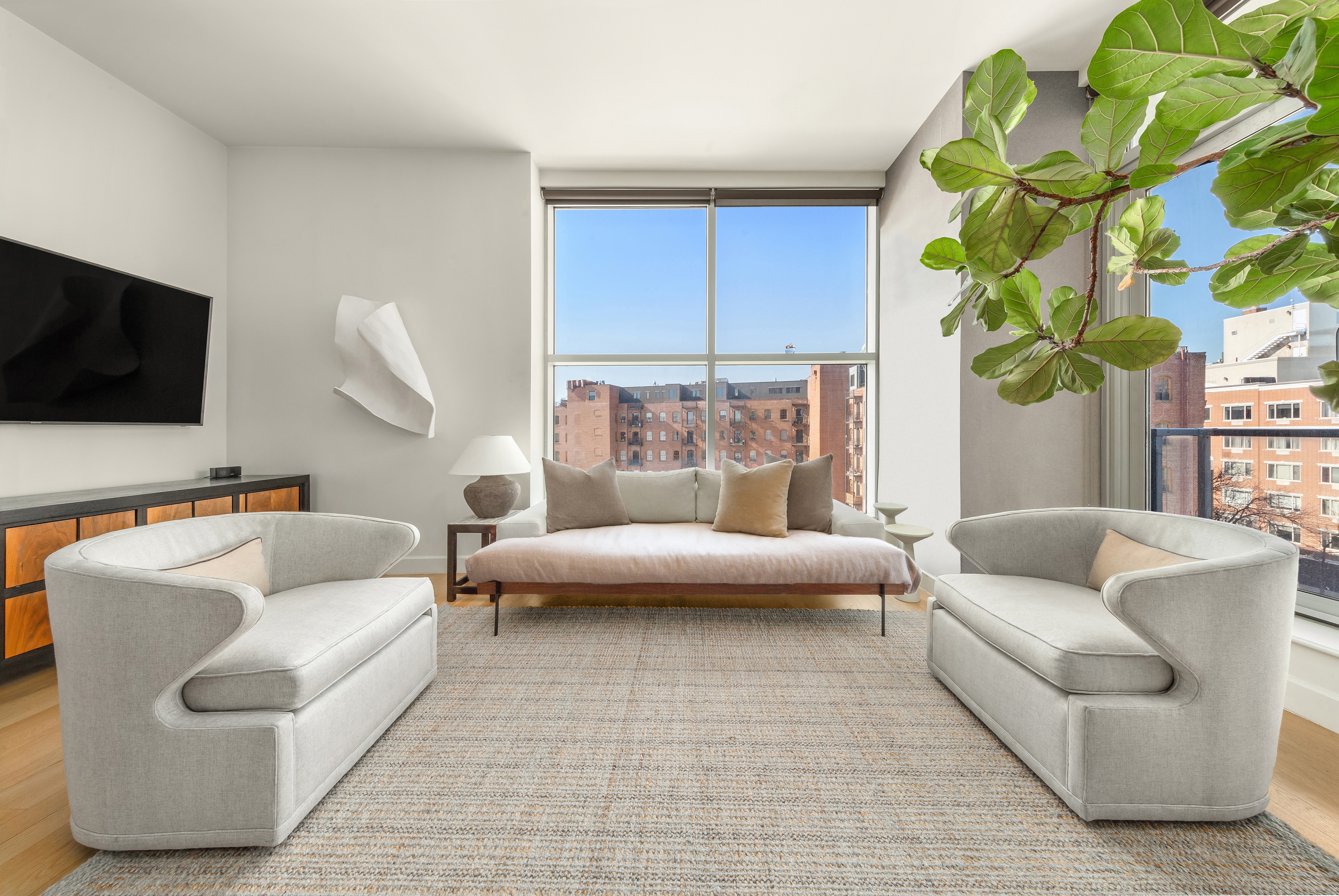 11-24 31st Avenue, Unit 5A Queens, NY 11106 - Photo 2 of 11 a living room with furniture and a flat screen tv