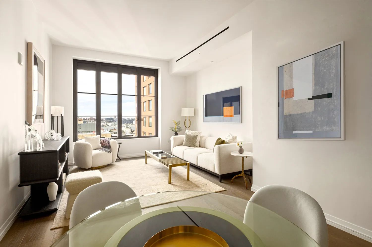 a living room with furniture and large windows