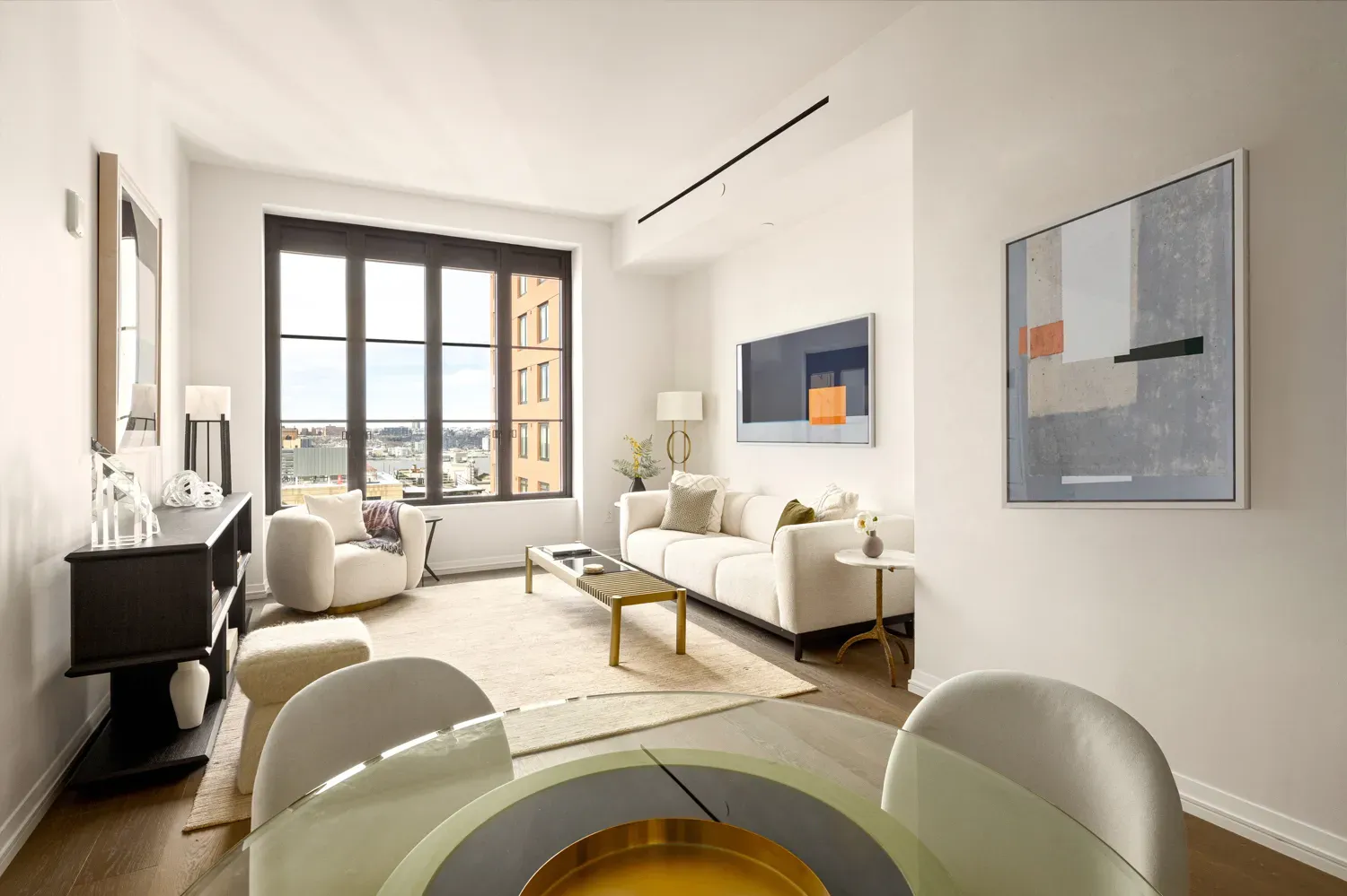 a living room with furniture and large windows