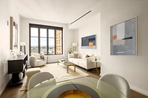 a living room with furniture and large windows