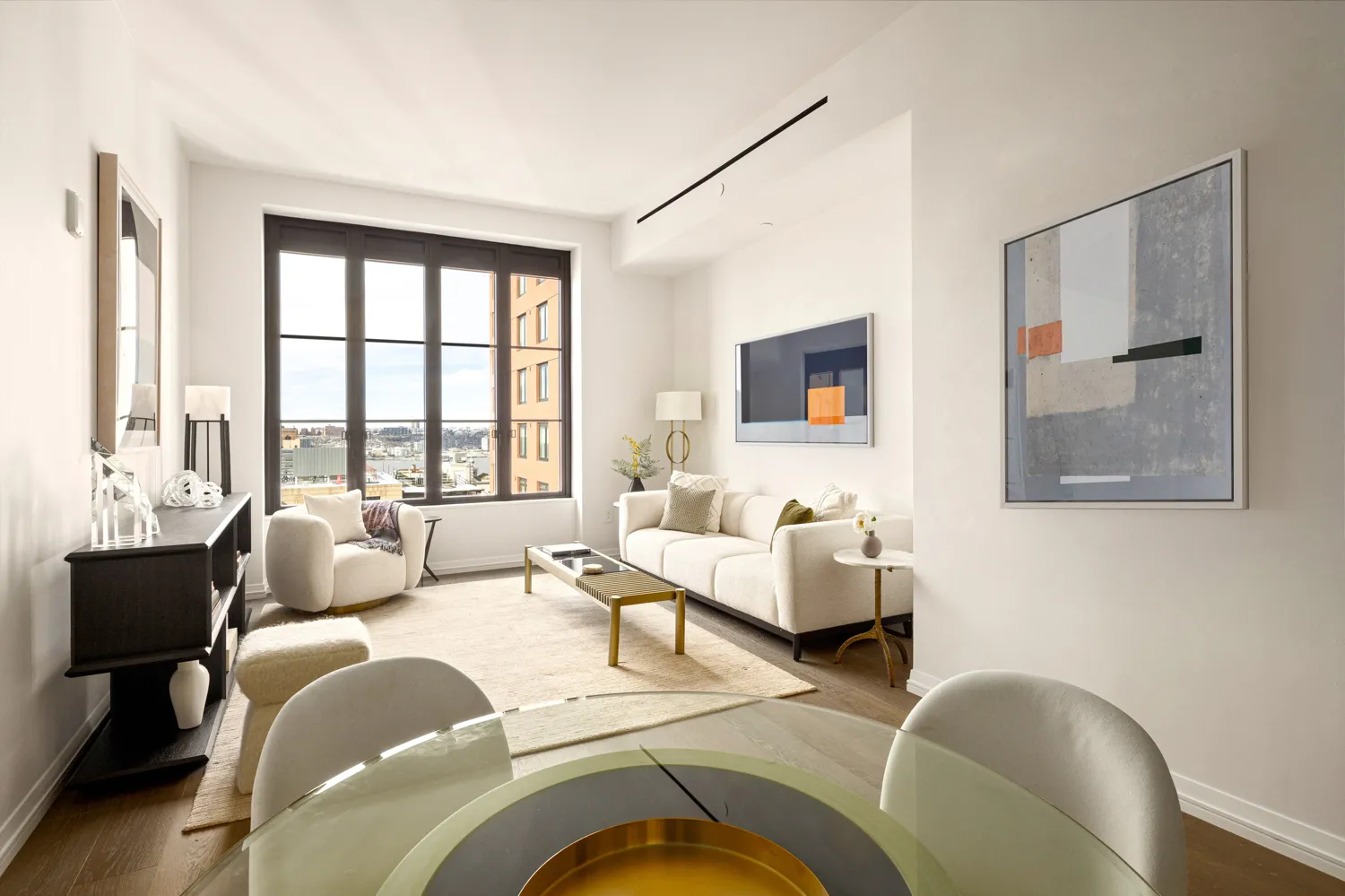 a living room with furniture and large windows