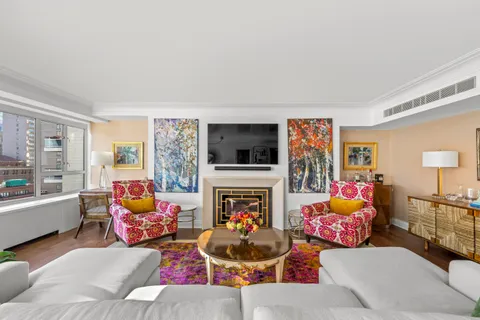 a living room with furniture fireplace and flat screen tv