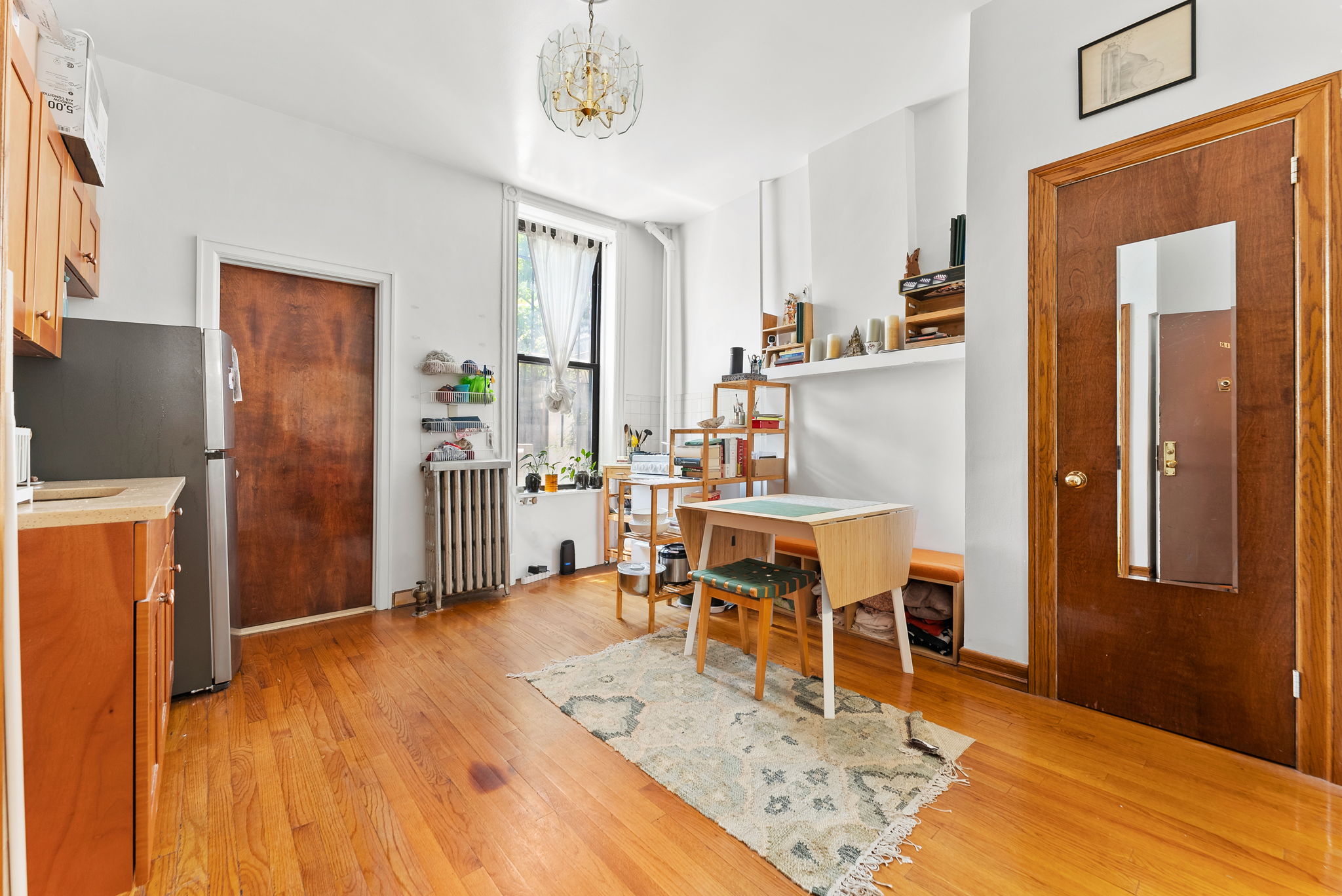 318 11th Street, Unit 1R Brooklyn, NY 11215 - Photo 2 of 7 a view of a dining hall with wooden floor and a sink