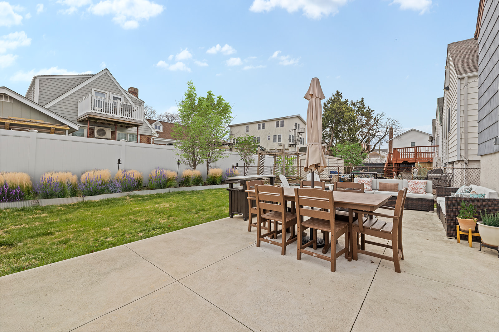 524 Beach 127th Street Queens, NY 11694 - Photo 15 of 18 a view of a patio with table and chairs and garden