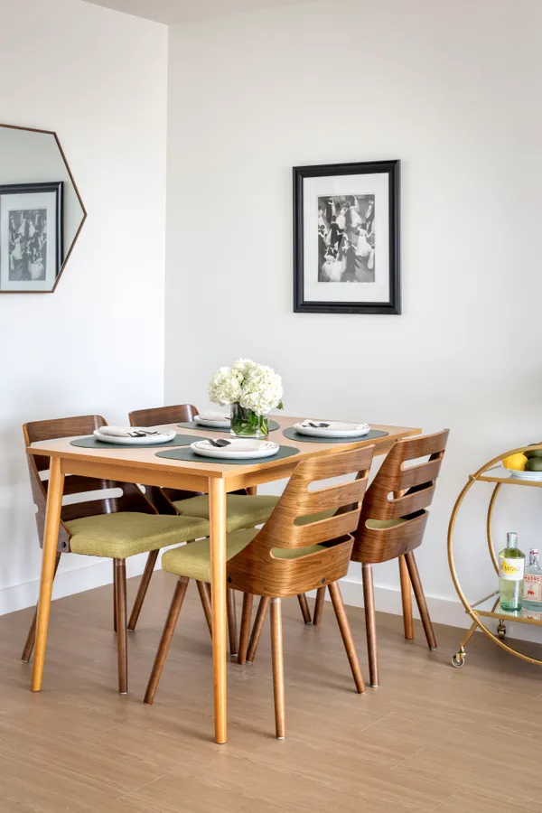 a dining room with furniture and wooden floor