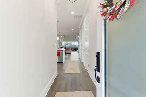 a view of a dining room with furniture wooden floor and chandelier