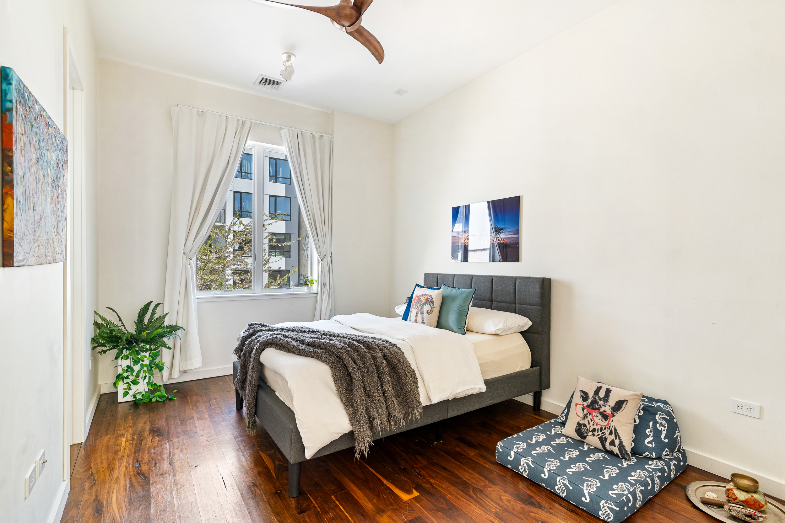 65 Jackson Street Brooklyn, NY 11211 - Photo 14 of 36 a bedroom with a bed and a potted plant