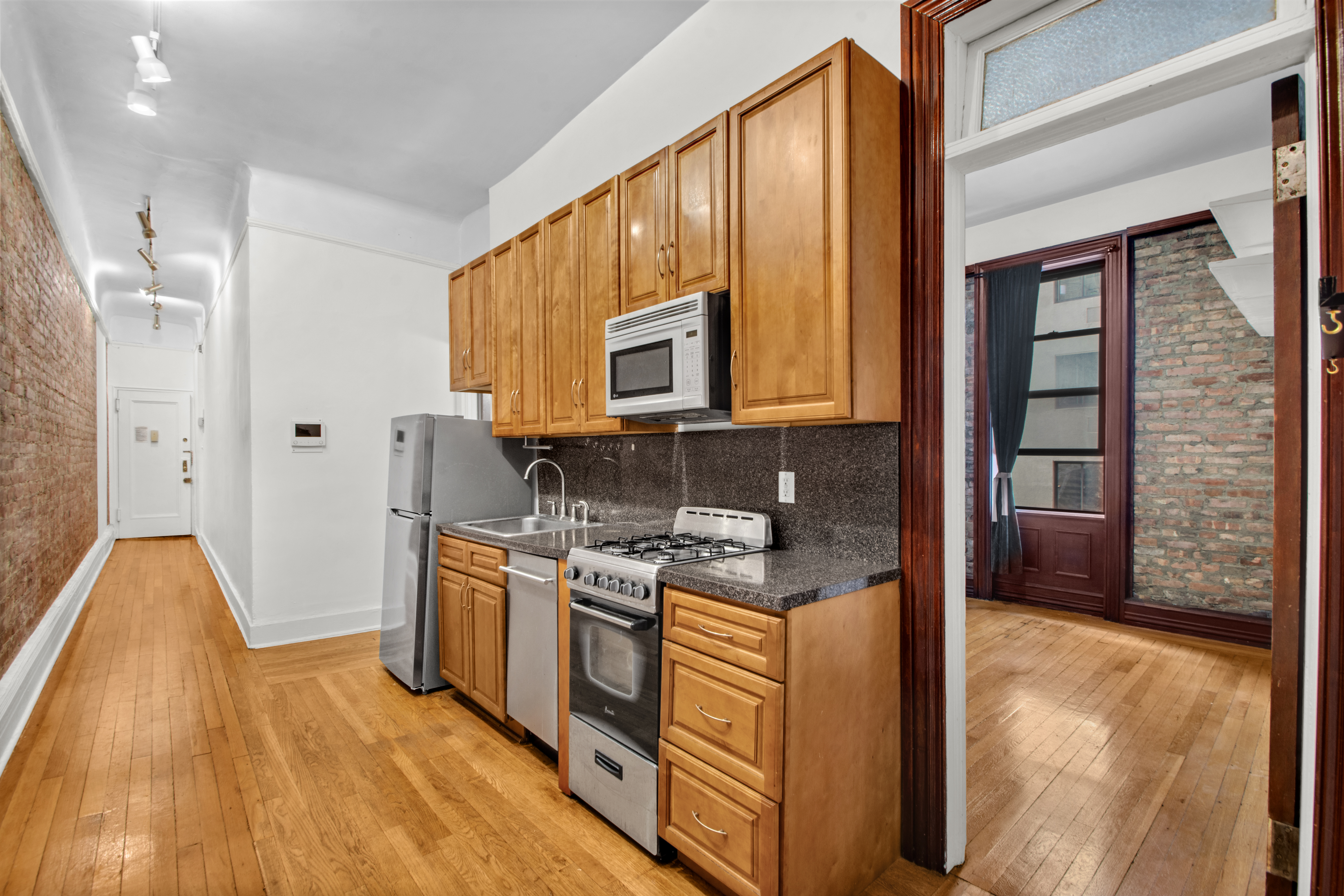 244 Riverside Drive, Unit 4D Manhattan, NY 10025 - Photo 2 of 9 a kitchen with stainless steel appliances granite countertop a stove a sink and a refrigerator