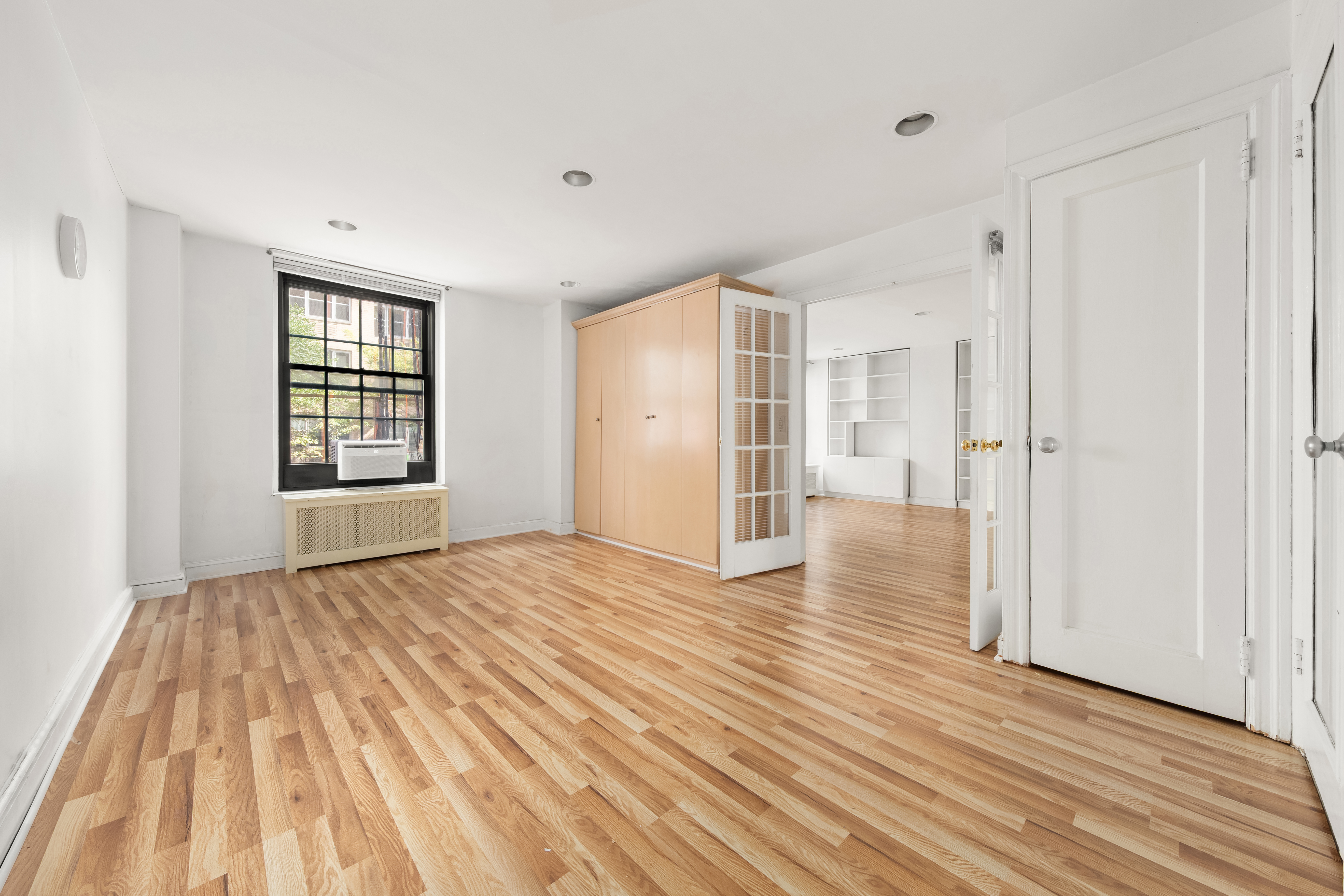 1 5th Avenue, Unit 2B Manhattan, NY 10003 - Photo 5 of 12 a view of empty room with wooden floor and window