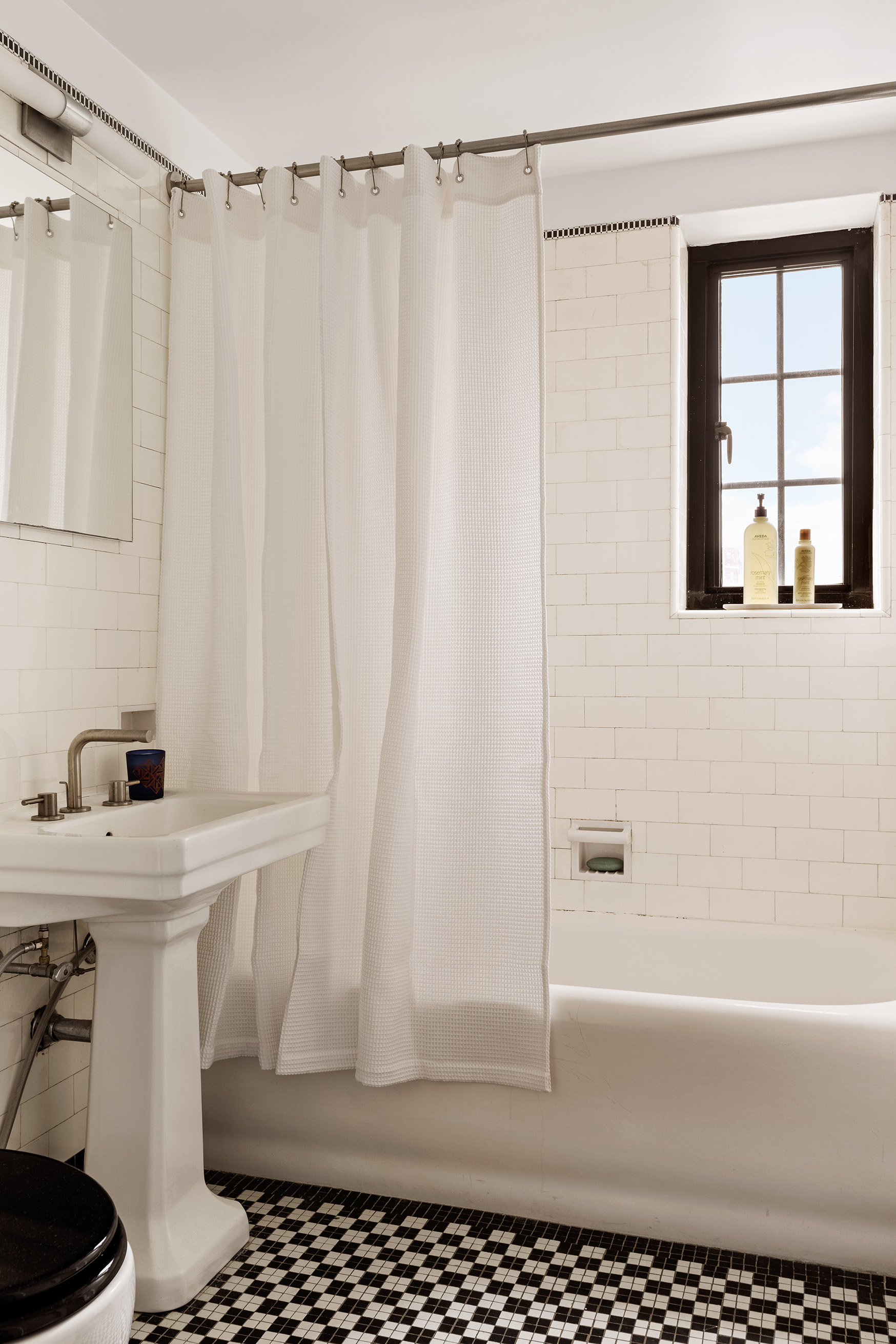 201 West 16th Street, Unit 9A Manhattan, NY 10011 - Photo 11 of 14 a bathroom with a sink a toilet a window and shower