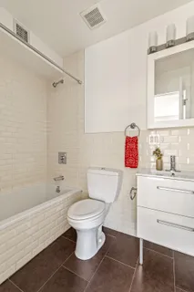 a bathroom with a sink toilet vanity and bathtub