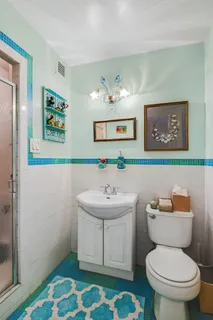 a bathroom with a sink mirror and toilet