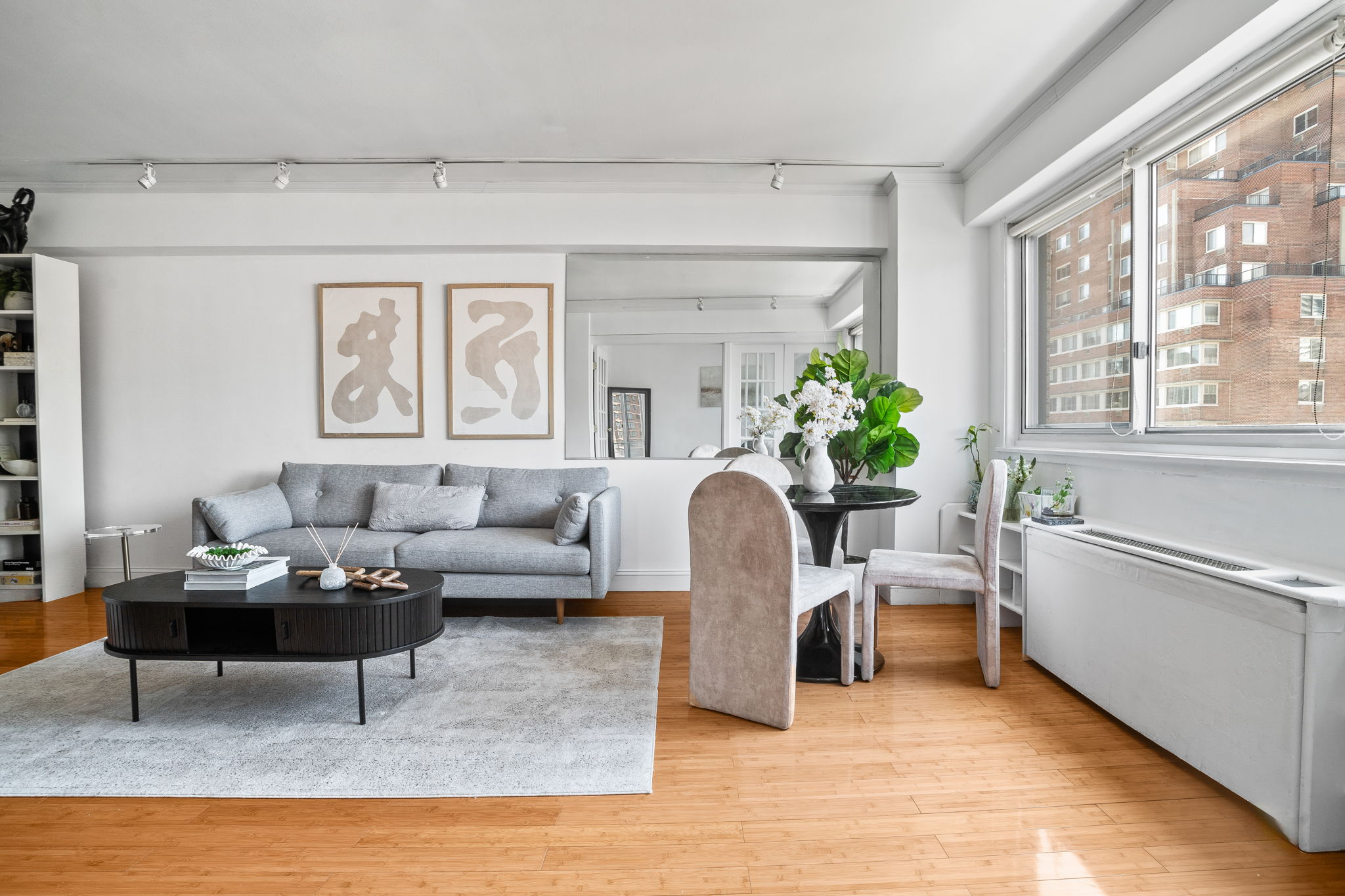 401 East 65th Street, Unit 12F Manhattan, NY 10065 - Photo 4 of 18 a living room with furniture or couch and a potted plant