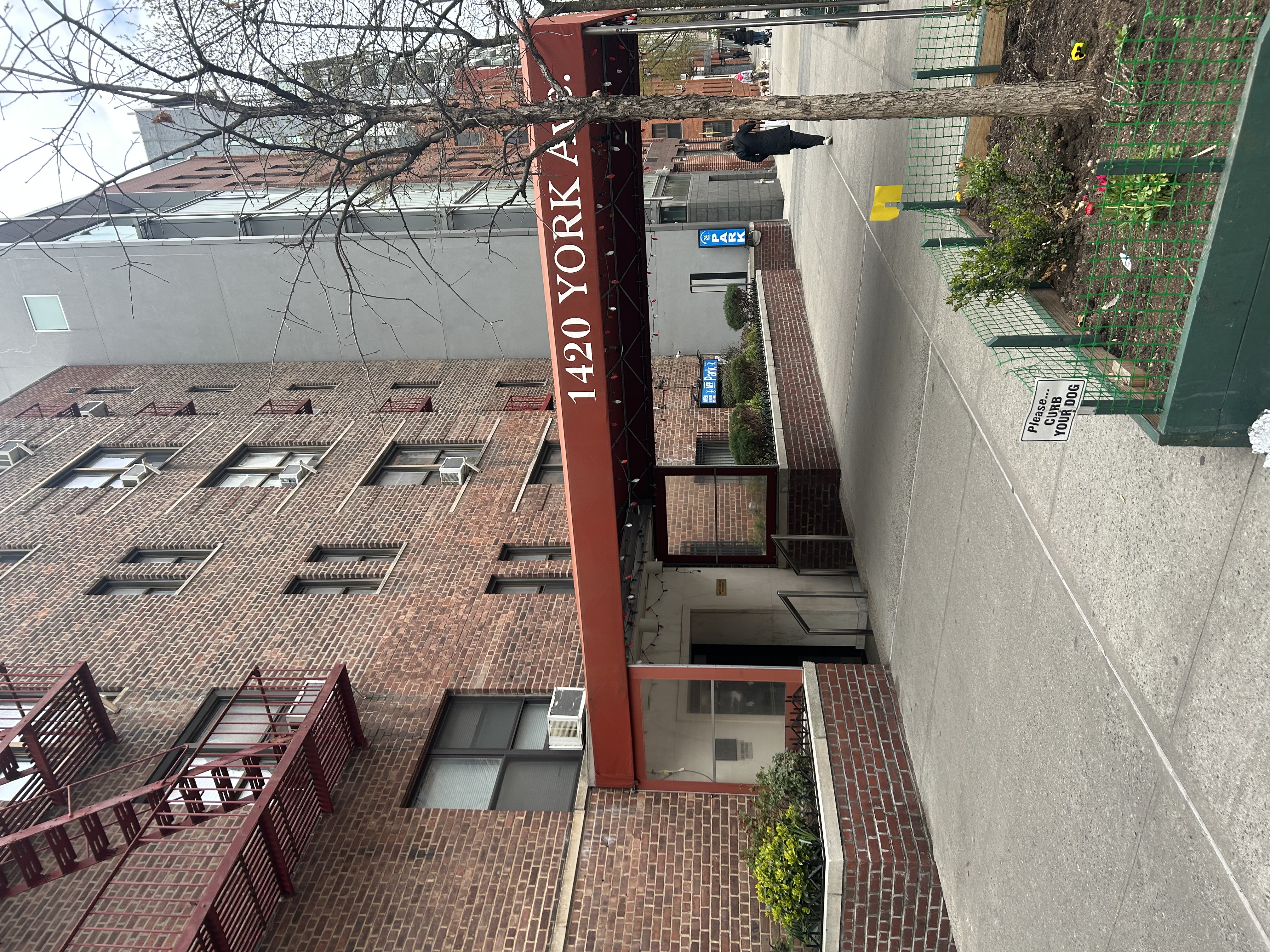 1420 York Avenue, Unit 6J Manhattan, NY 10021 - Photo 11 of 13 a front view of a building with street