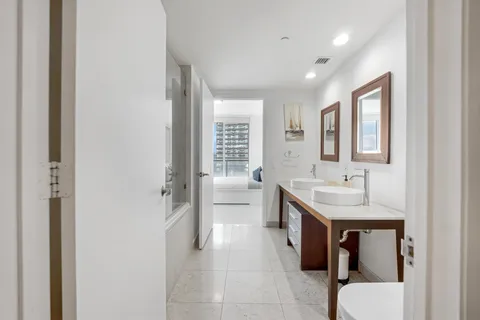 a spacious bathroom with a toilet sink and mirror