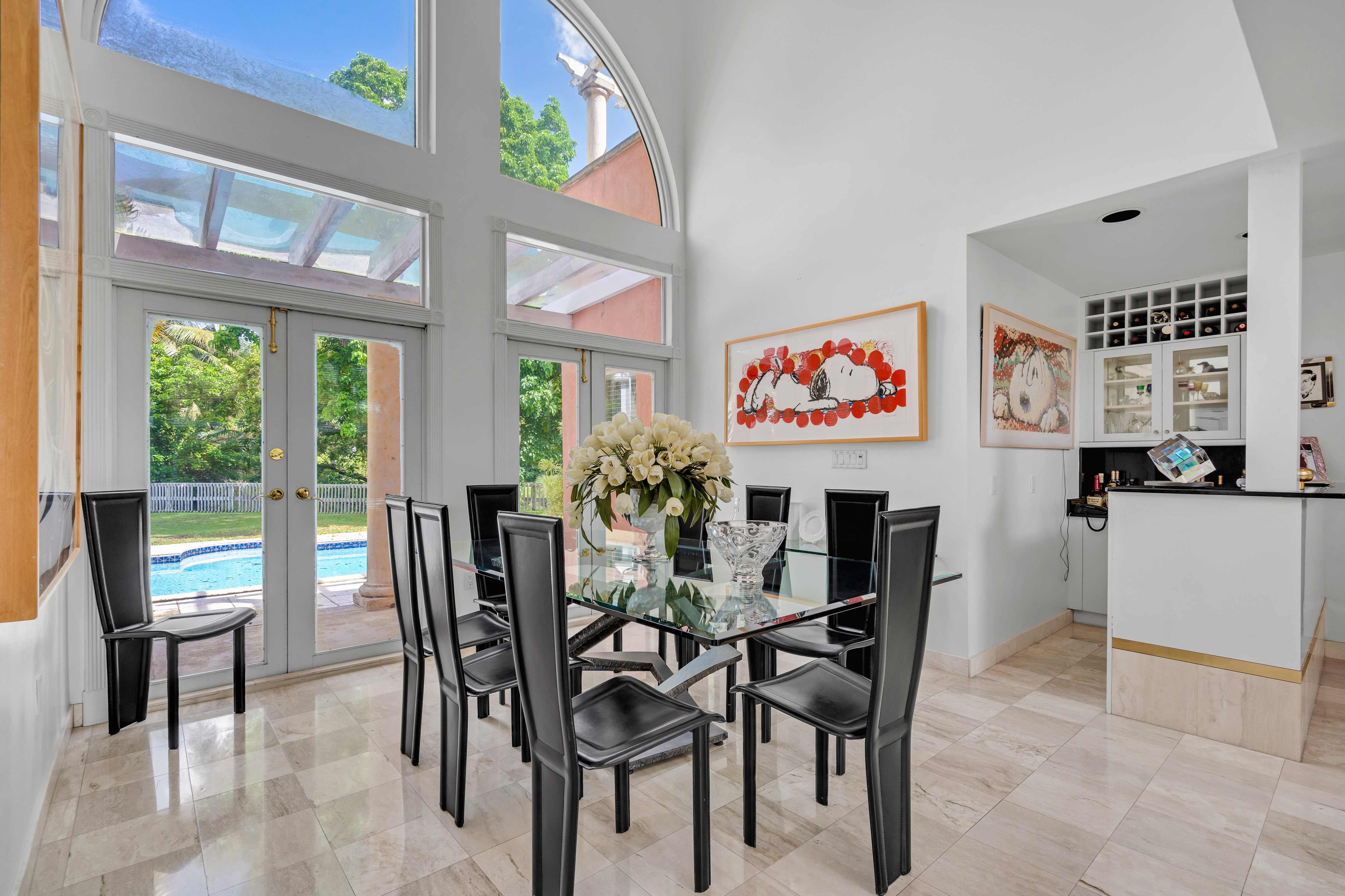 8768 Southwest 62nd Court Miami, FL 33156 - Photo 11 of 56 a view of a dining room with furniture a chandelier and a painting