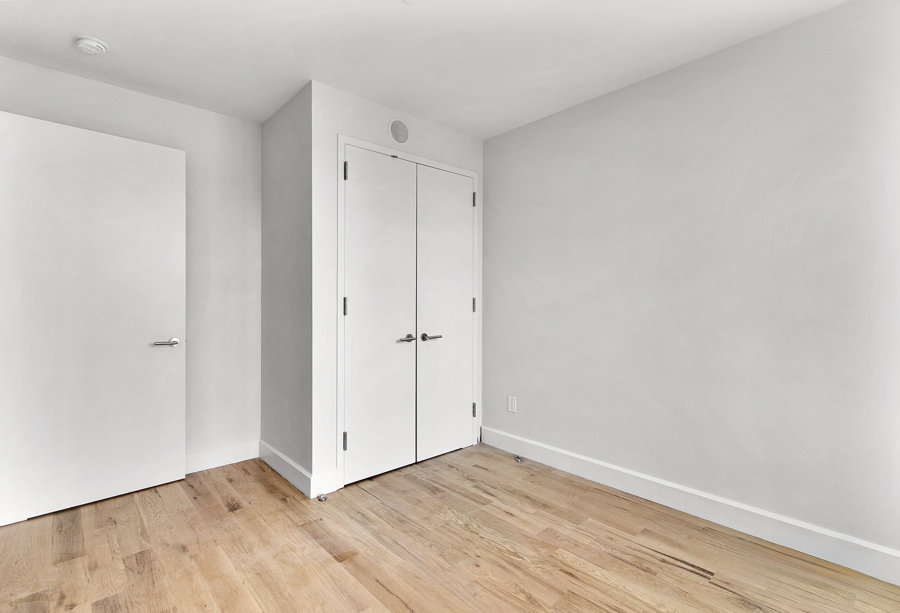 1098 Madison Street, Unit 1B Brooklyn, NY 11221 - Photo 8 of 16 a view of an empty room with wooden floor