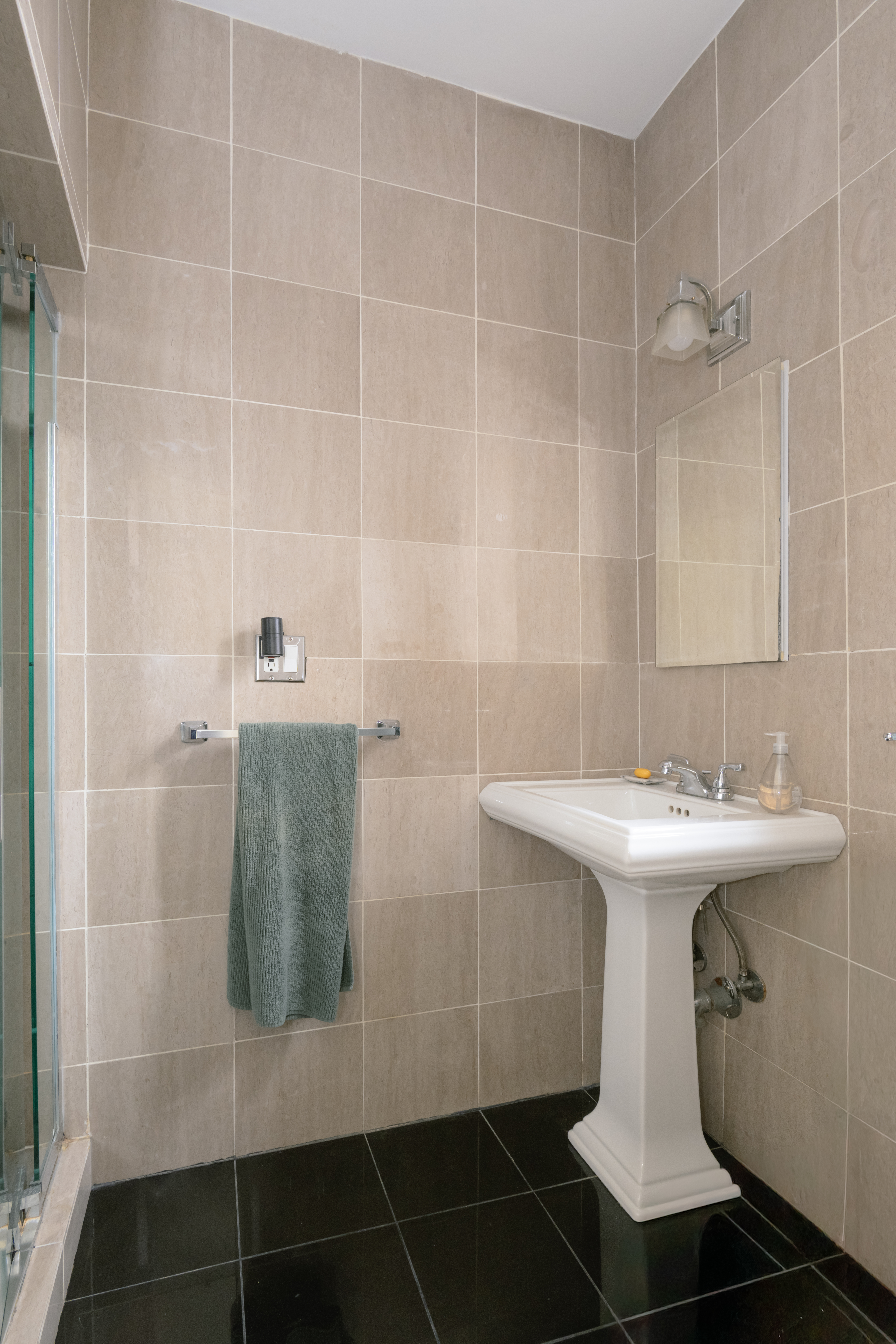 25 Minetta Lane, Unit 6G Manhattan, NY 10012 - Photo 6 of 13 a bathroom with a sink and a mirror