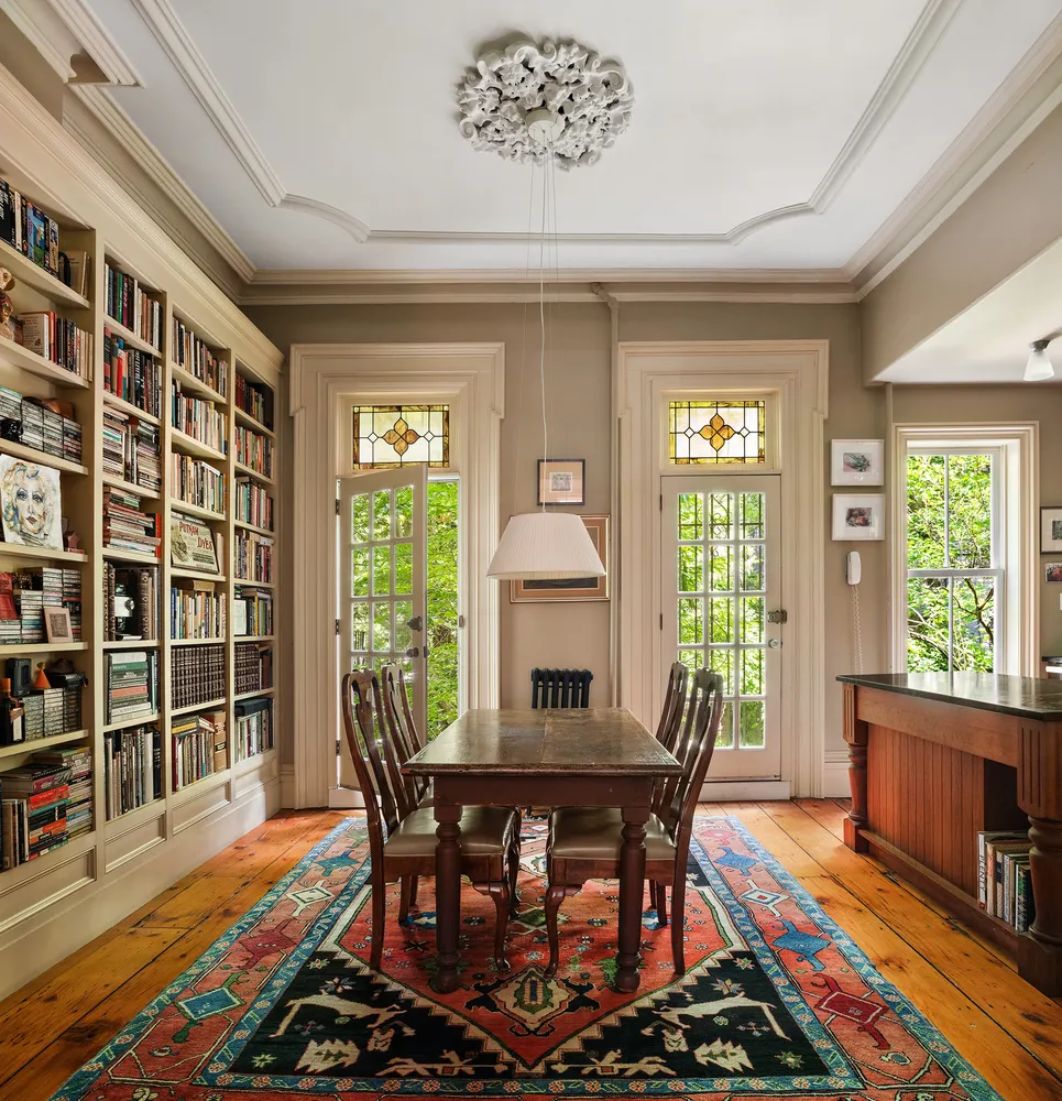 a dining room with furniture and wooden floor