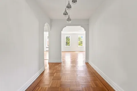 a view of hallway with wooden floor