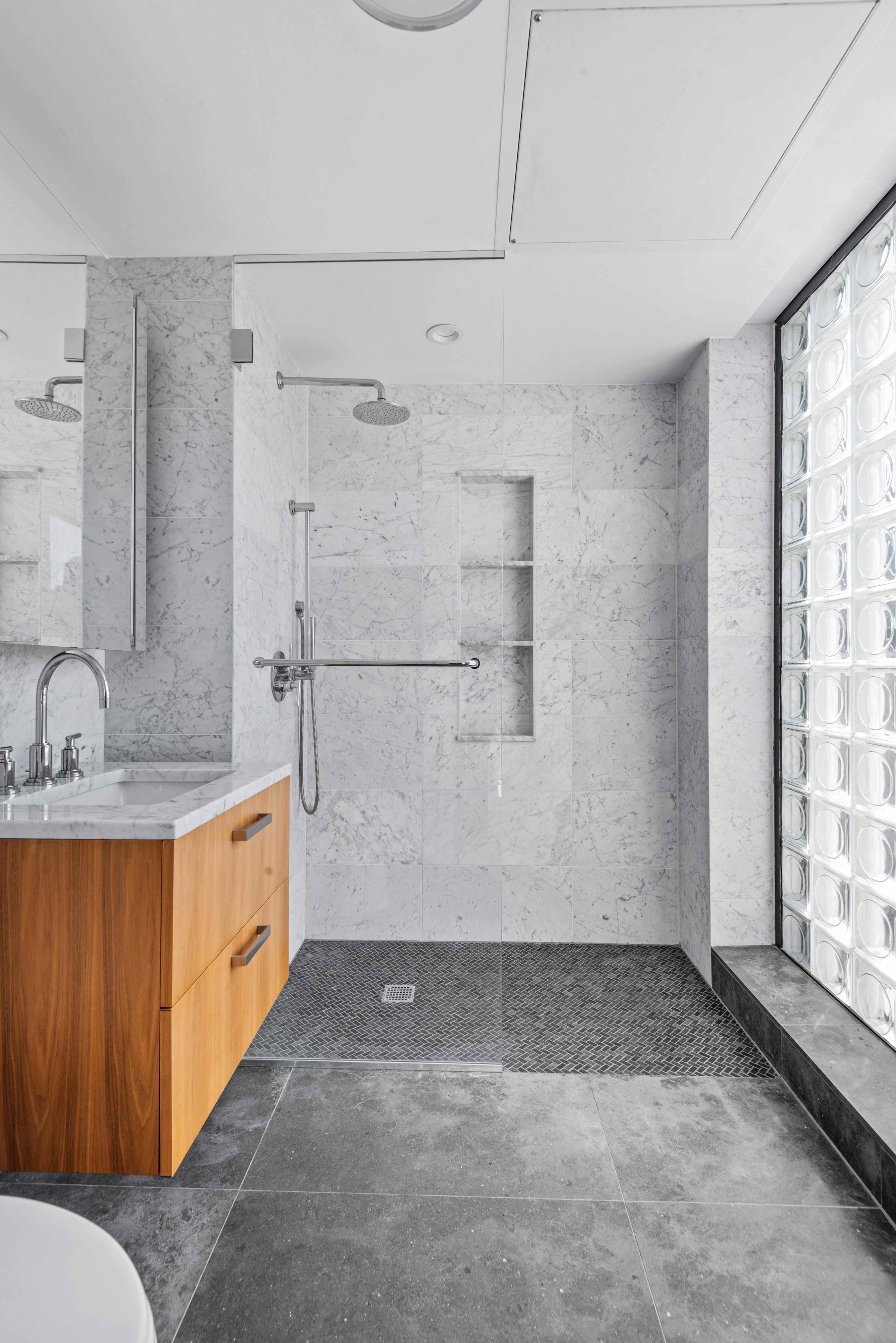 476 Union Avenue, Unit PH5A Brooklyn, NY 11211 - Photo 10 of 17 a bathroom with a granite countertop sink a toilet and shower