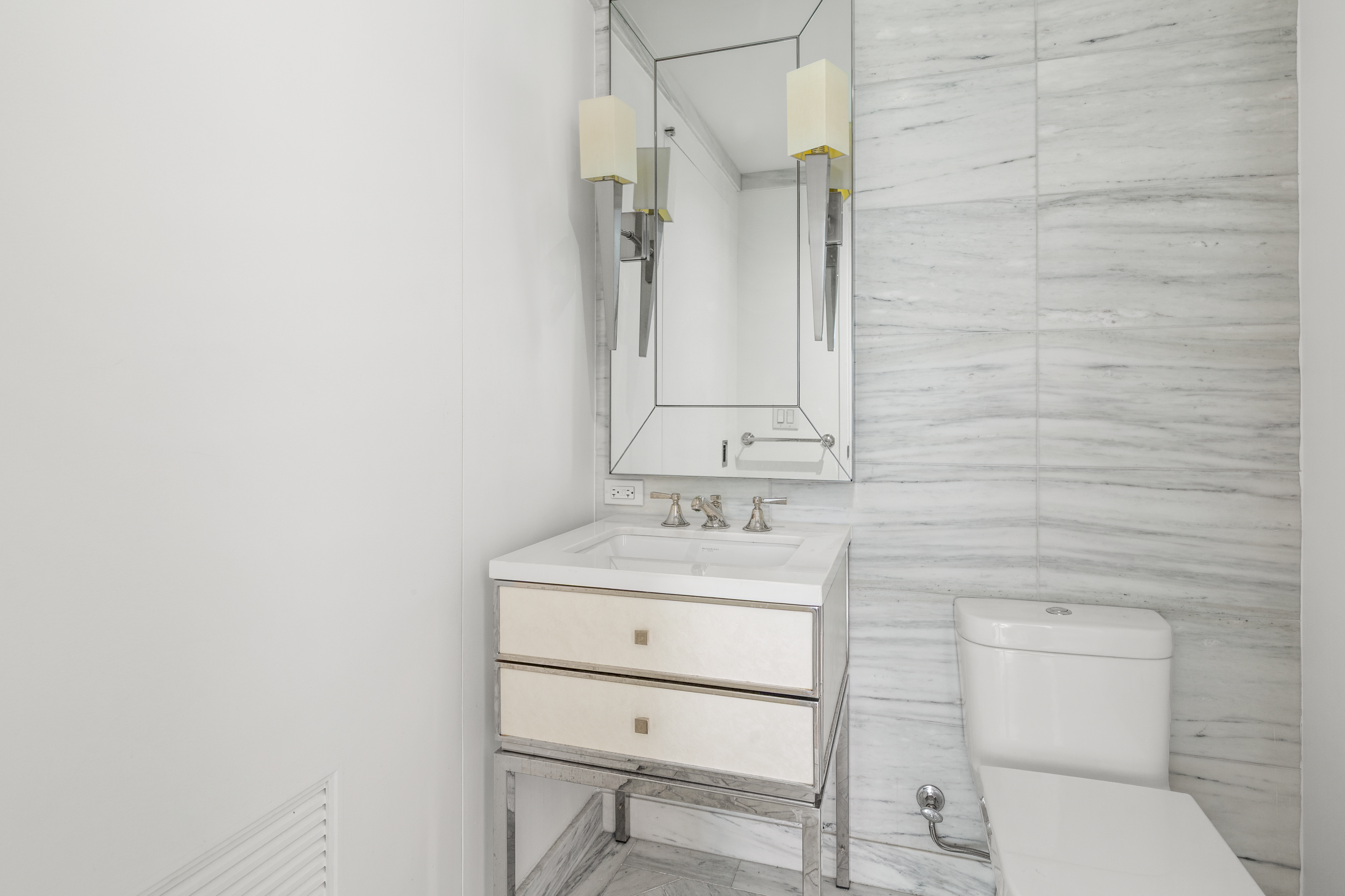 212 Warren Street, Unit 3B Manhattan, NY 10282 - Photo 8 of 11 a bathroom with a toilet a sink and mirror