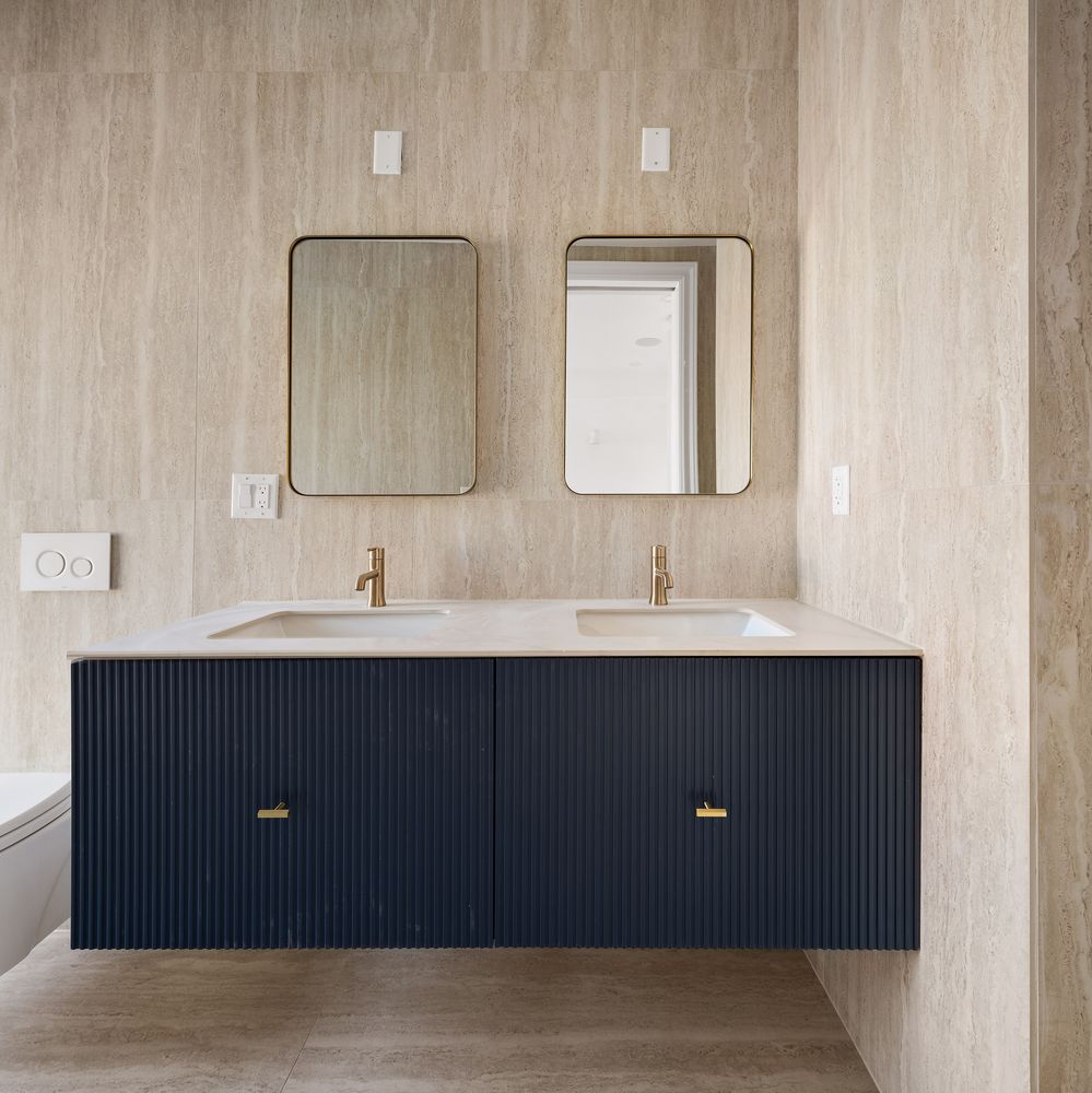 a bathroom with a sink vanity and mirror