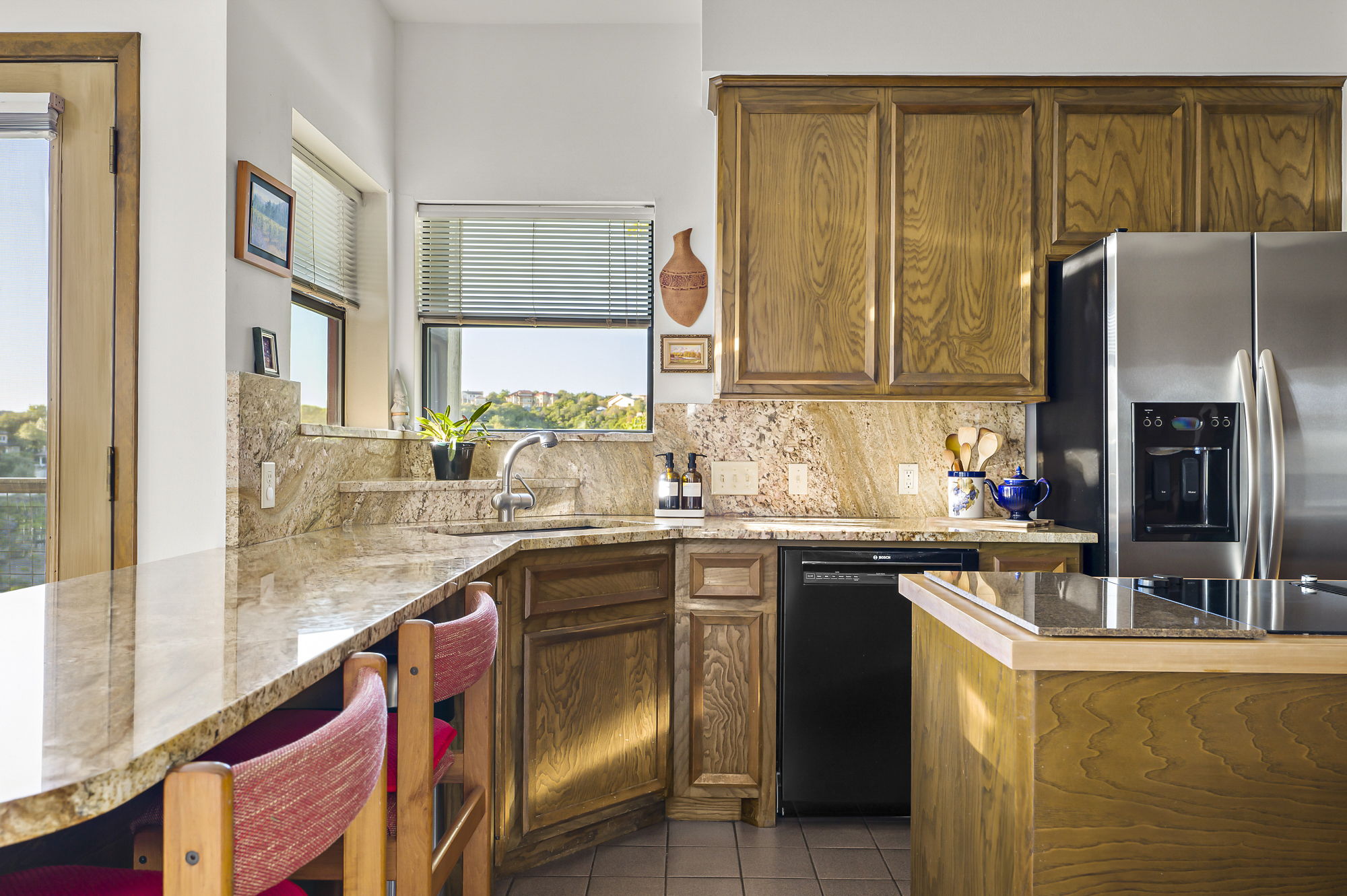 1605 The High Road Austin, TX 78746 - Photo 13 of 45 a kitchen with stainless steel appliances granite countertop a sink and a refrigerator