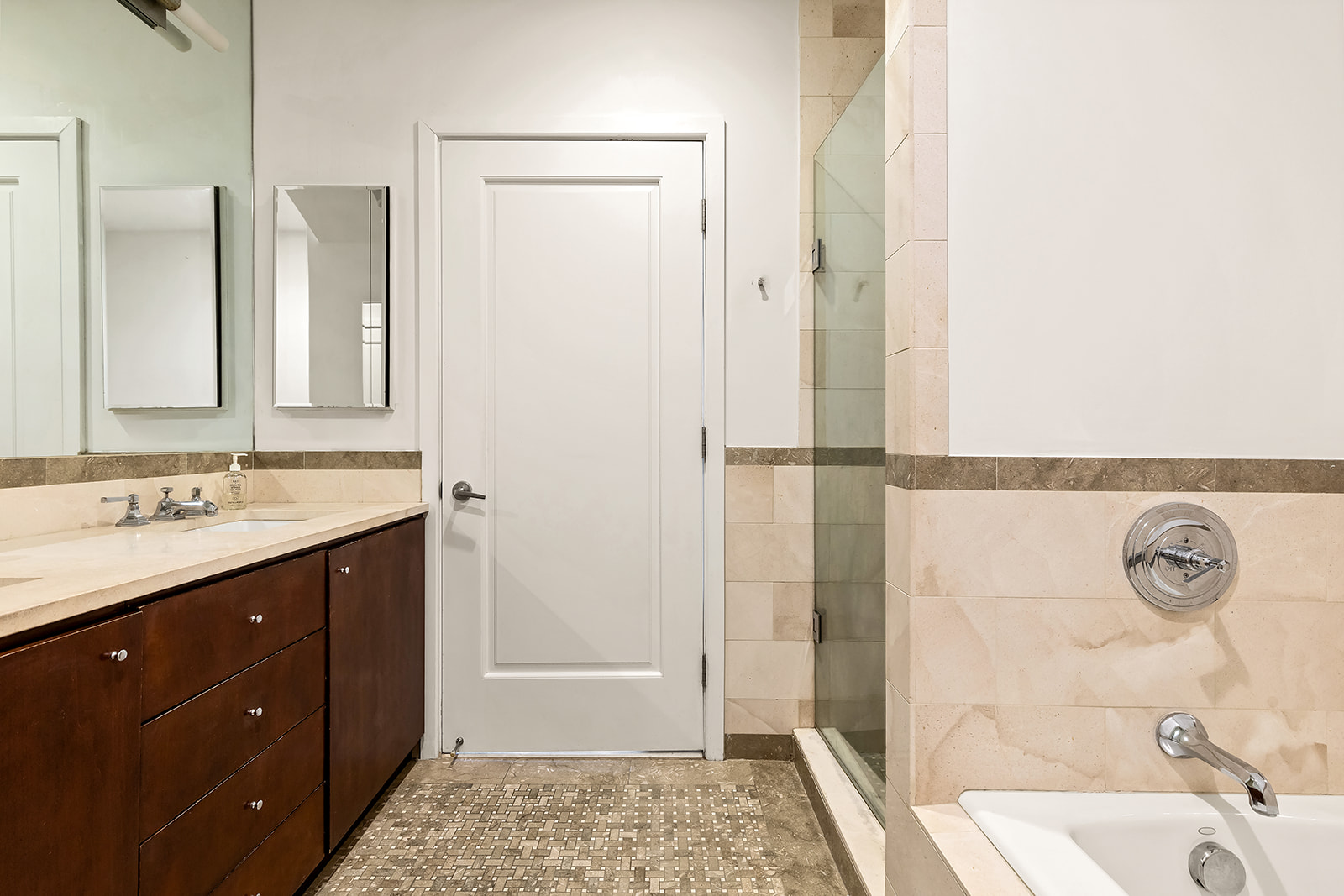 1 Hanson Place, Unit 11J Brooklyn, NY 11243 - Photo 7 of 10 a bathroom with a sink vanity granite tub shower and a mirror