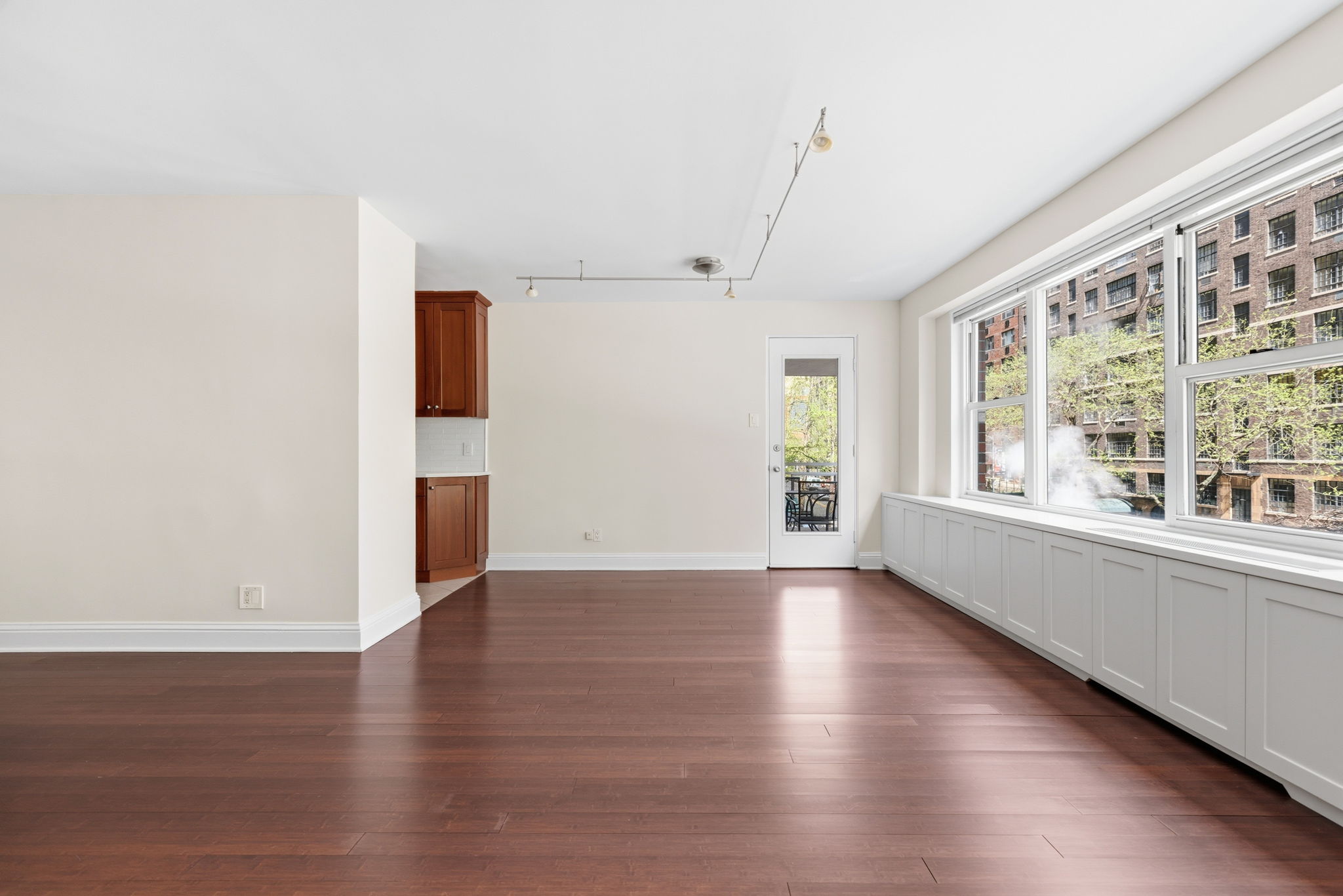 360 East 72nd Street, Unit A306 Manhattan, NY 10021 - Photo 9 of 17 a view of an empty room with wooden floor and a window