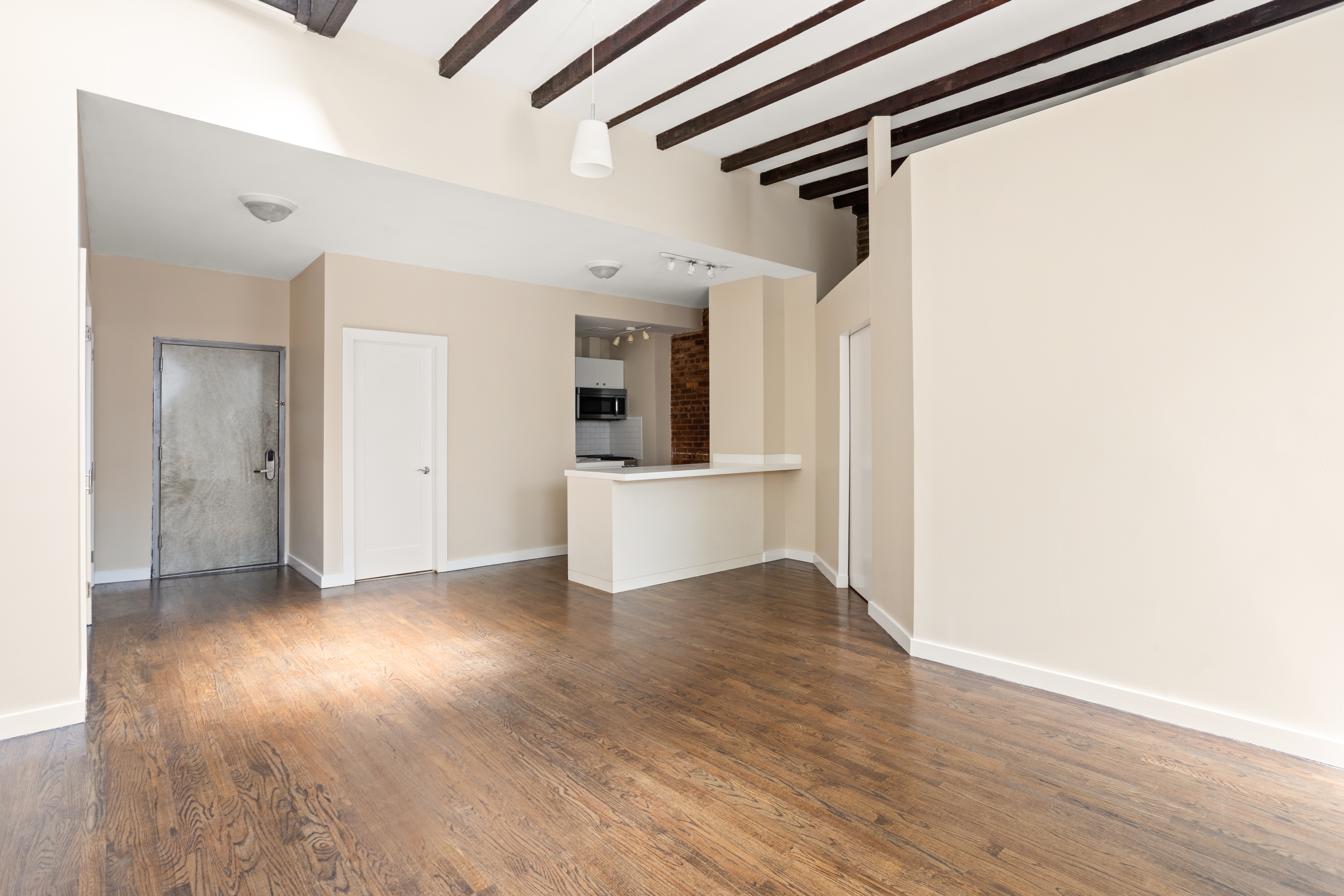22 East 13th Street, Unit 2R Manhattan, NY 10003 - Photo 2 of 8 a view of a kitchen with wooden floor and a sink