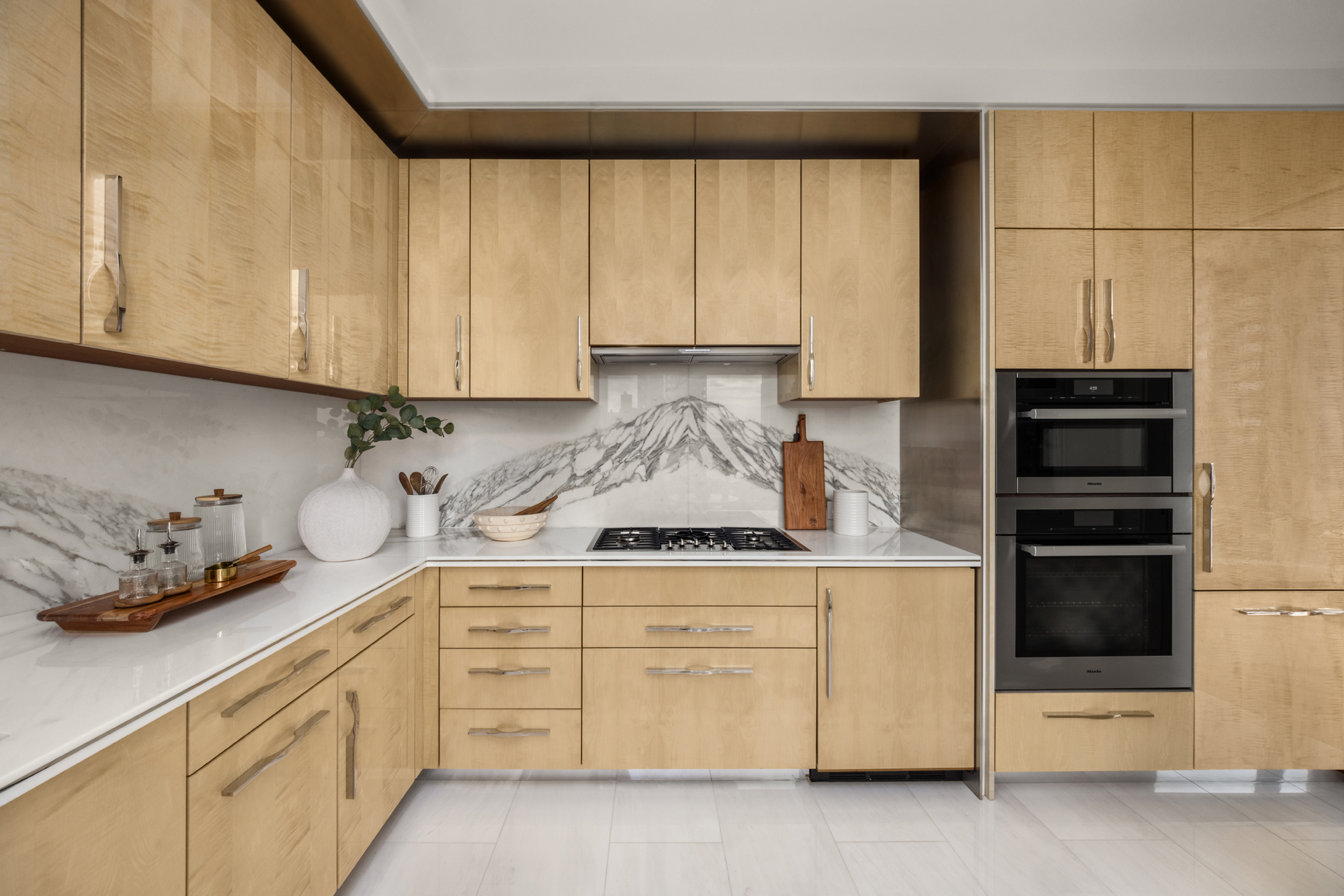 217 West 57th Street, Unit 34F Manhattan, NY 10019 - Photo 6 of 25 a kitchen with granite countertop white cabinets and stainless steel appliances