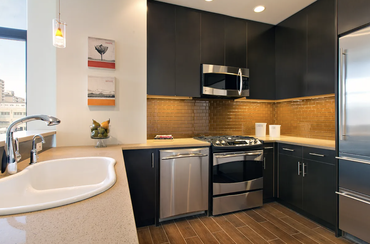 a kitchen with stainless steel appliances granite countertop a sink and a stove