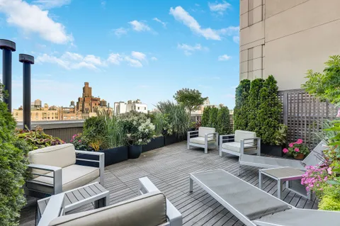 a view of a terrace with couches and potted plants