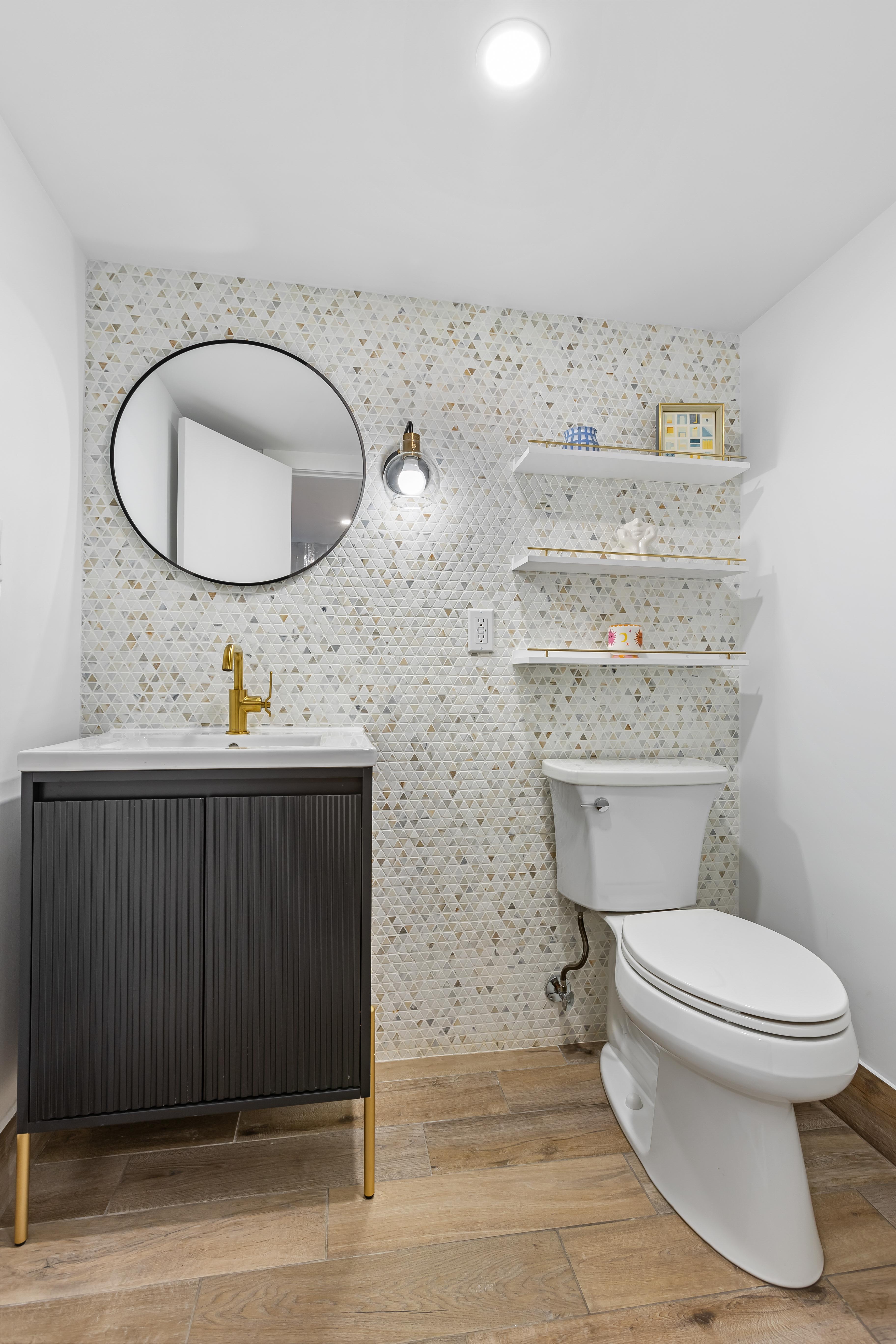 227 Garfield Place, Unit Garden Duplex Brooklyn, NY 11215 - Photo 13 of 15 a bathroom with a toilet a sink and mirror