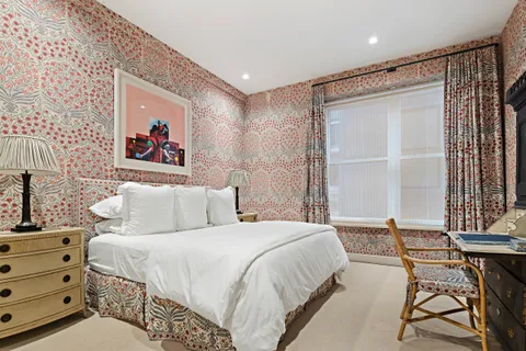 a bed room with a bed and a chair