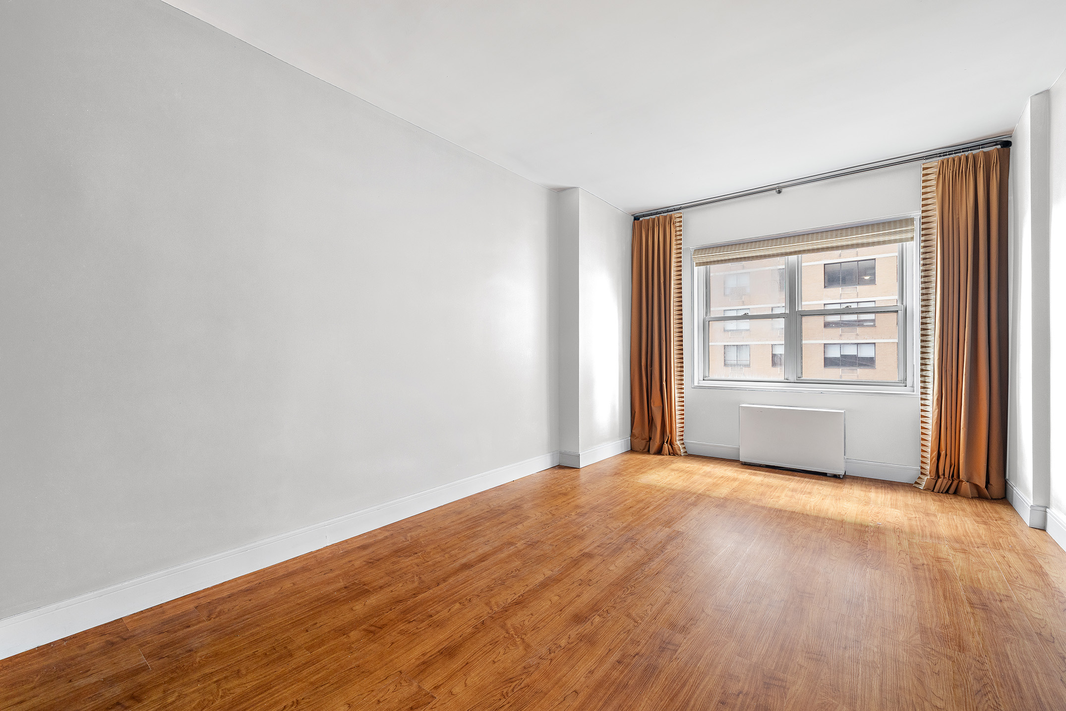 60 East 8th Street, Unit 20P Manhattan, NY 10003 - Photo 5 of 11 wooden floor in an empty room with a window