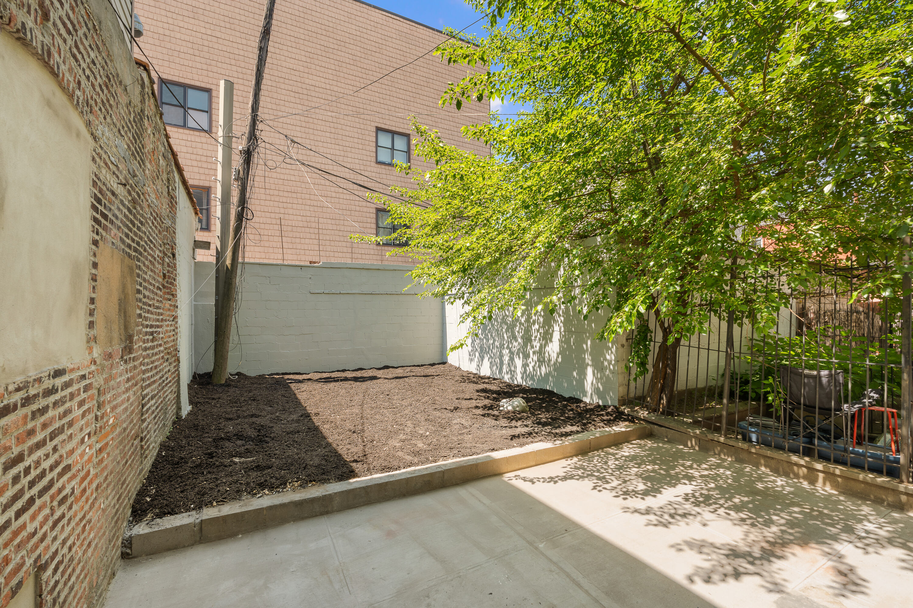 92 Wilson Avenue Brooklyn, NY 11237 - Photo 11 of 15 a view of a backyard of the house