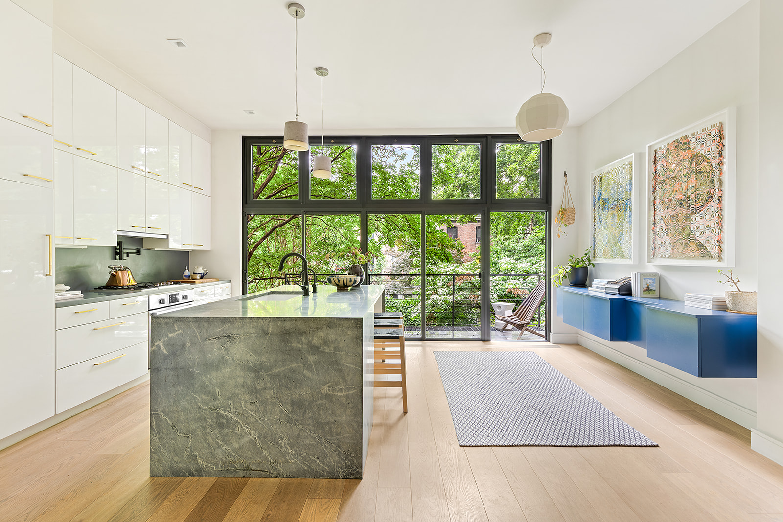 a living room with stainless steel appliances granite countertop furniture and a large window