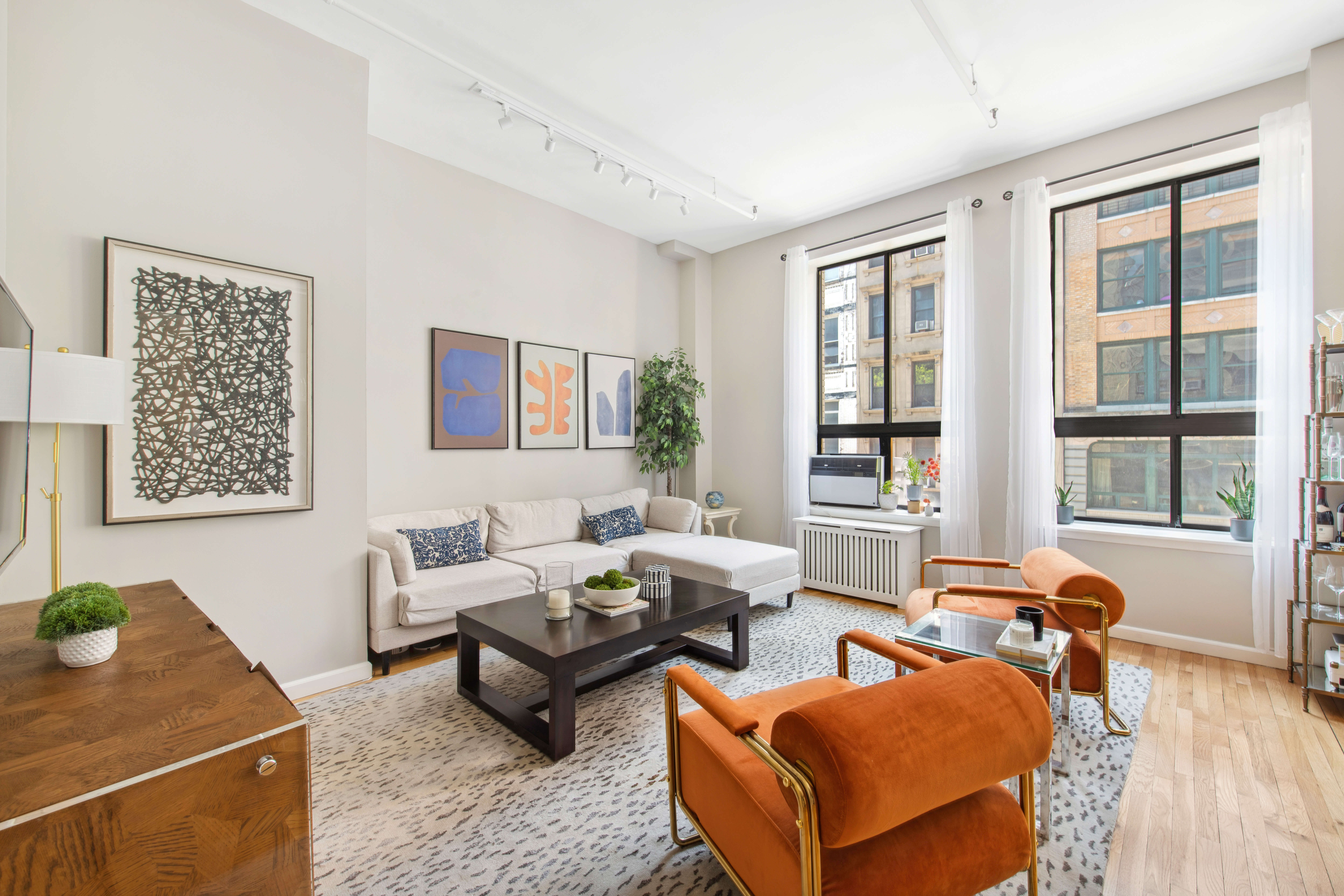 112 West 18th Street, Unit 2A Manhattan, NY 10011 - Photo 2 of 10 a living room with furniture and wooden floor