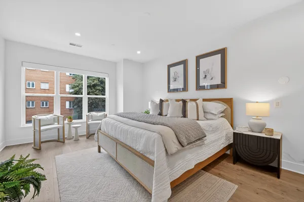 a bedroom with a large bed and a window