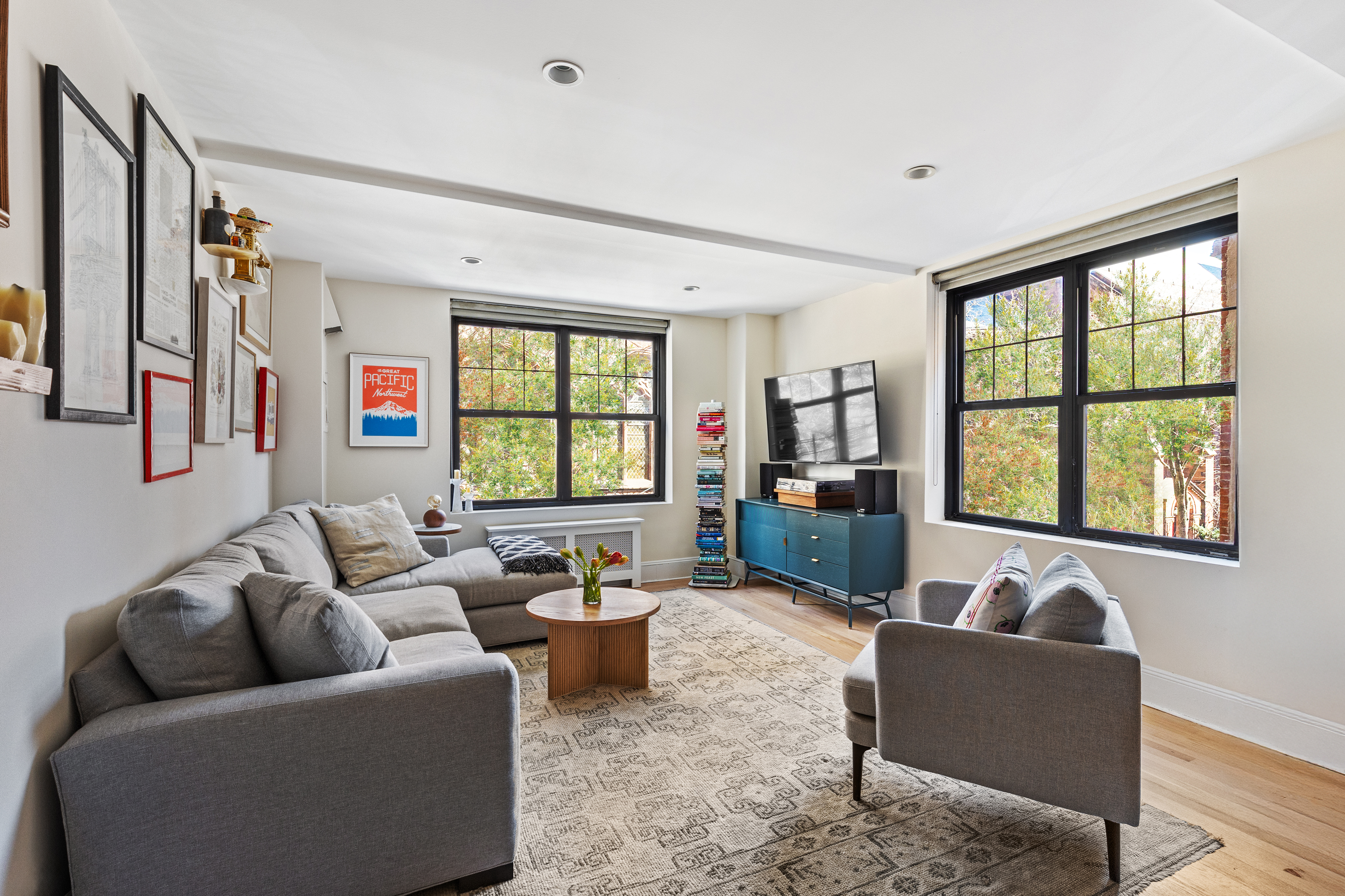 200 East 16th Street, Unit 3AB Manhattan, NY 10003 - Photo 1 of 12 a living room with furniture and a large window