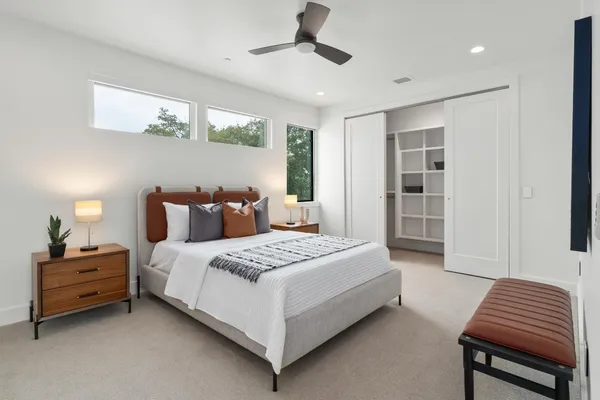 a living room with furniture and a ceiling fan