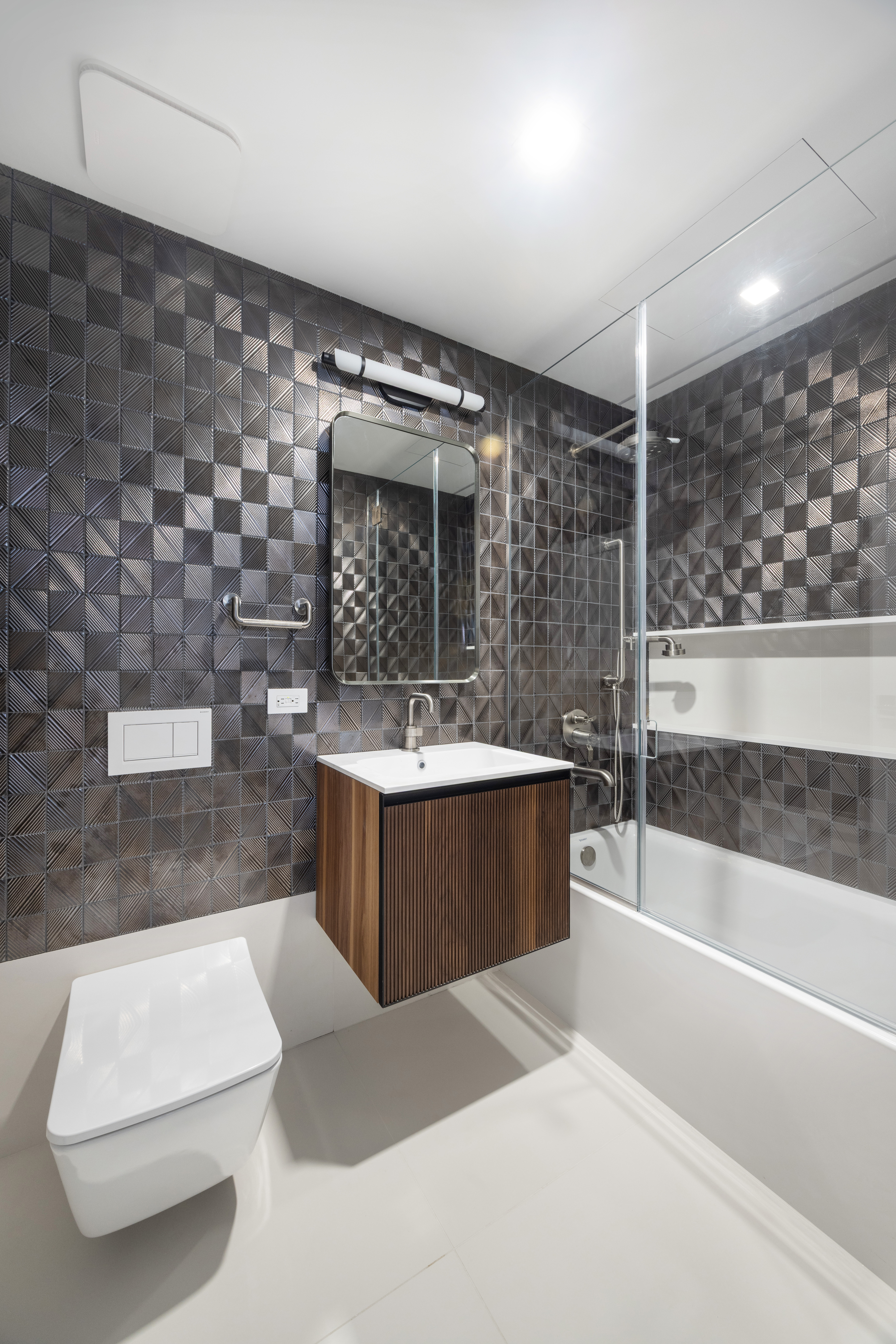 340 Albany Street Manhattan, NY 10280 - Photo 17 of 24 a bathroom with a sink a bathtub a mirror and a shower