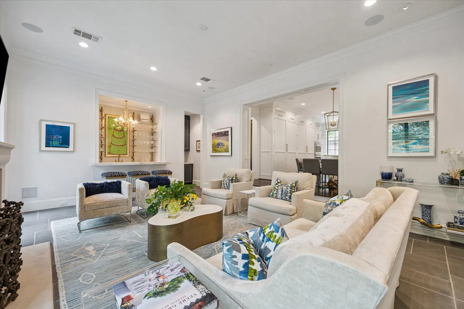 a living room with furniture potted plant and open kitchen view