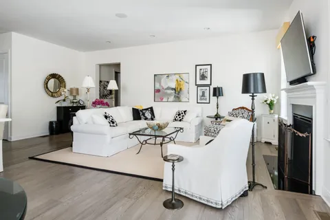 a living room with fireplace furniture and a flat screen tv