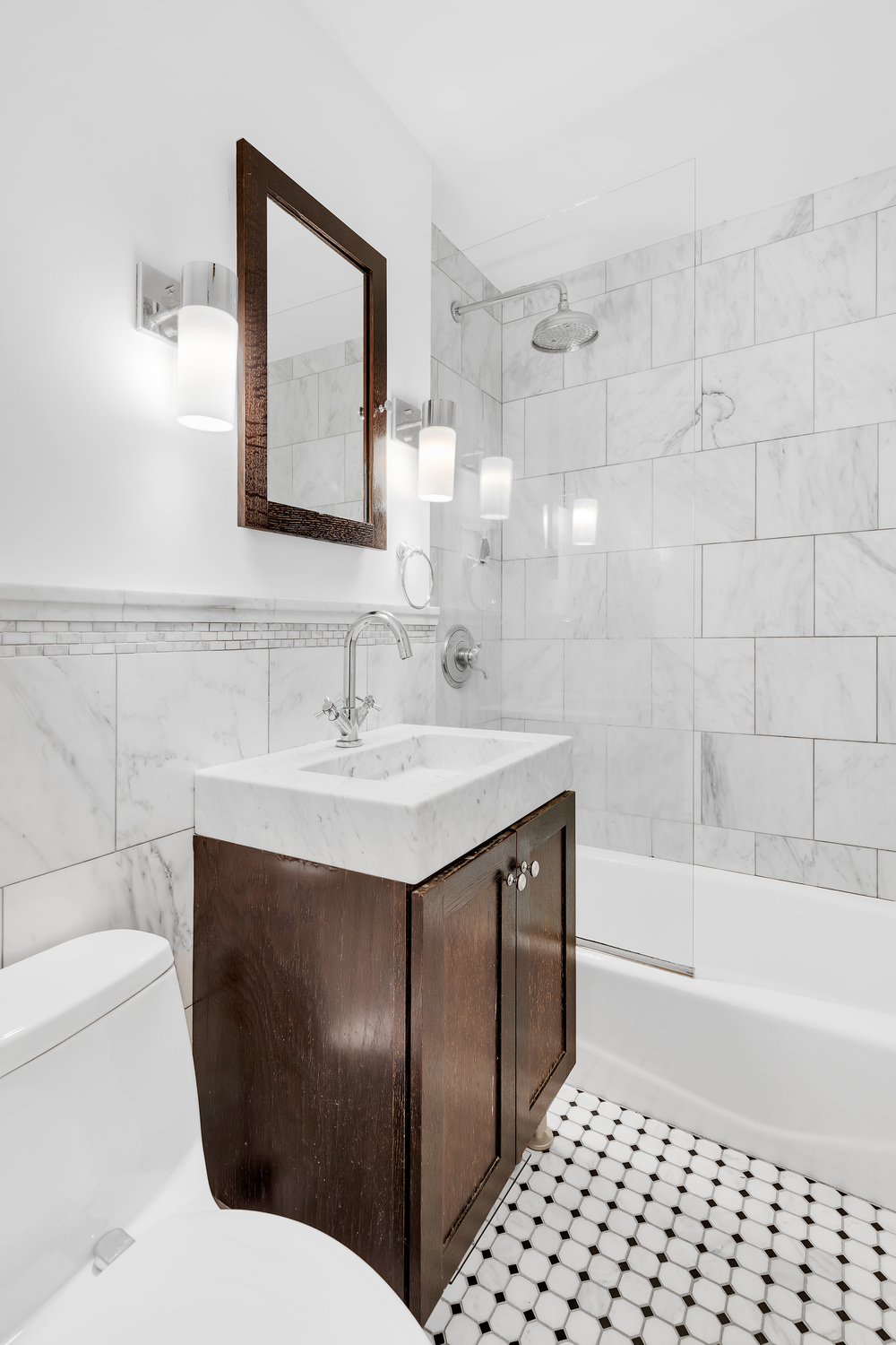 16 West 16th Street, Unit 2LN Manhattan, NY 10011 - Photo 5 of 11 a bathroom with a sink toilet and shower