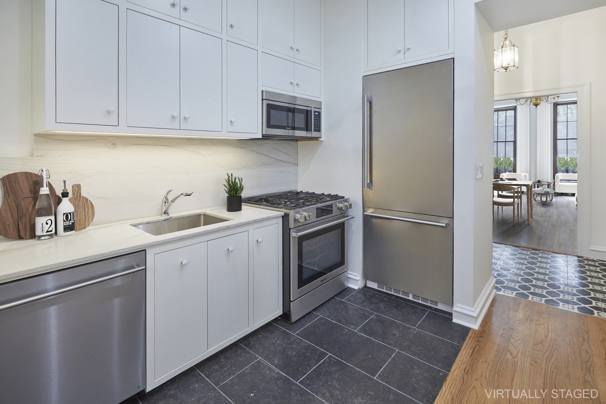 157 East 75th Street, Unit 1E Manhattan, NY 10021 - Photo 2 of 21 a kitchen with a sink appliances and cabinets