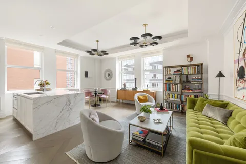 a living room with furniture and chandelier