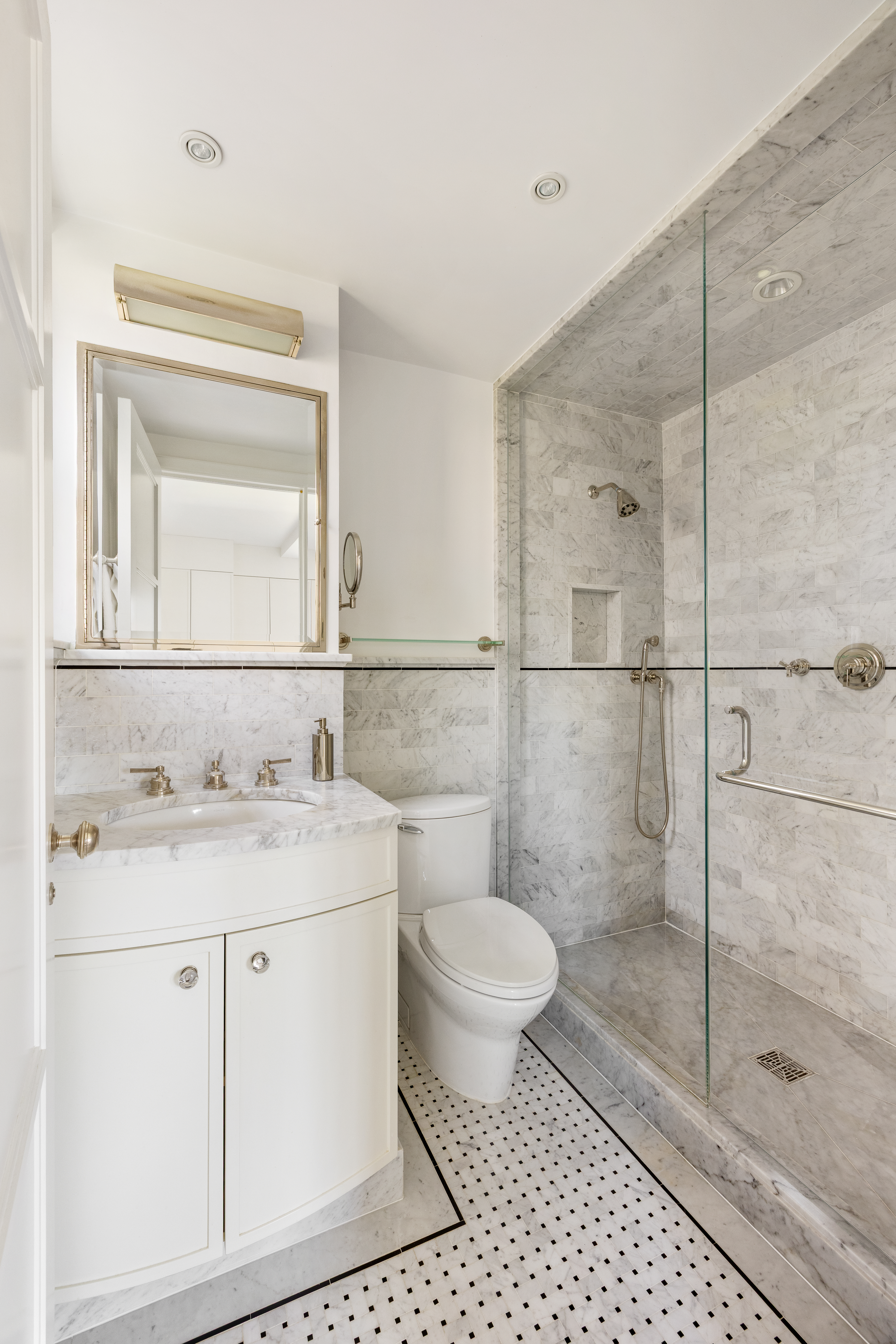 333 East 68th Street, Unit 8A Manhattan, NY 10065 - Photo 7 of 16 a bathroom with a granite countertop sink a toilet and a mirror